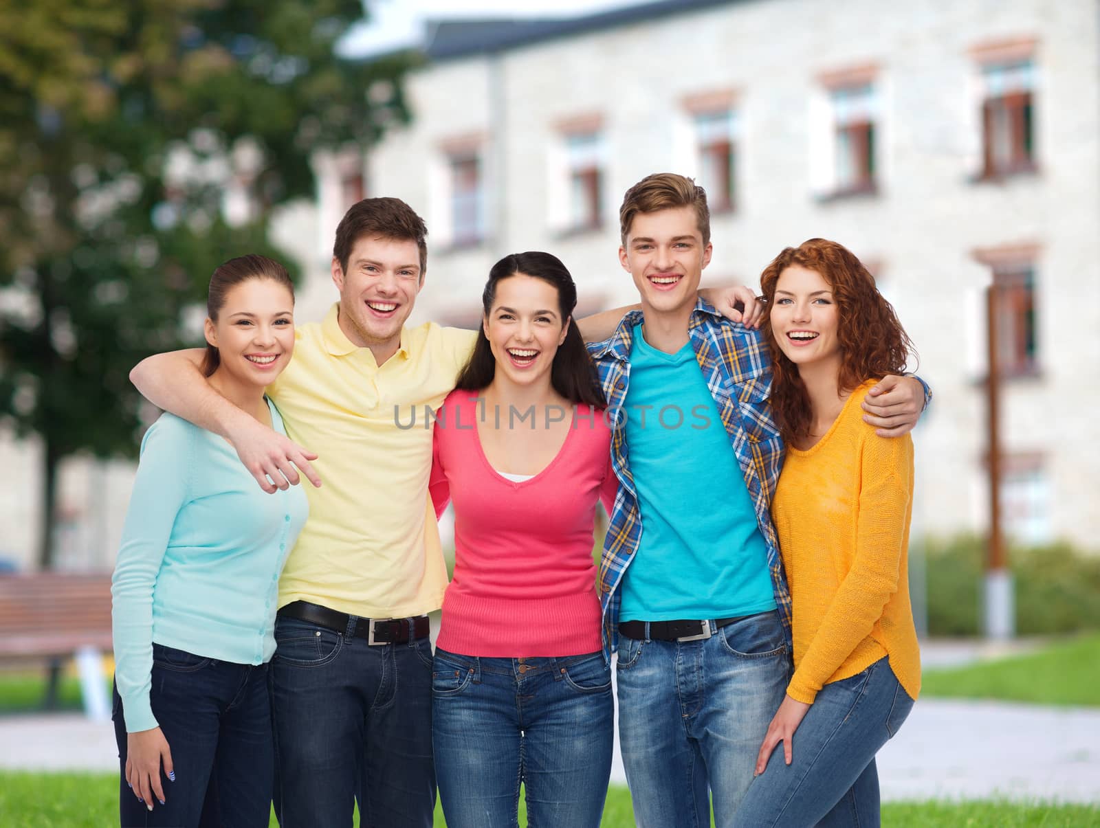 group of smiling teenagers over campus background by dolgachov