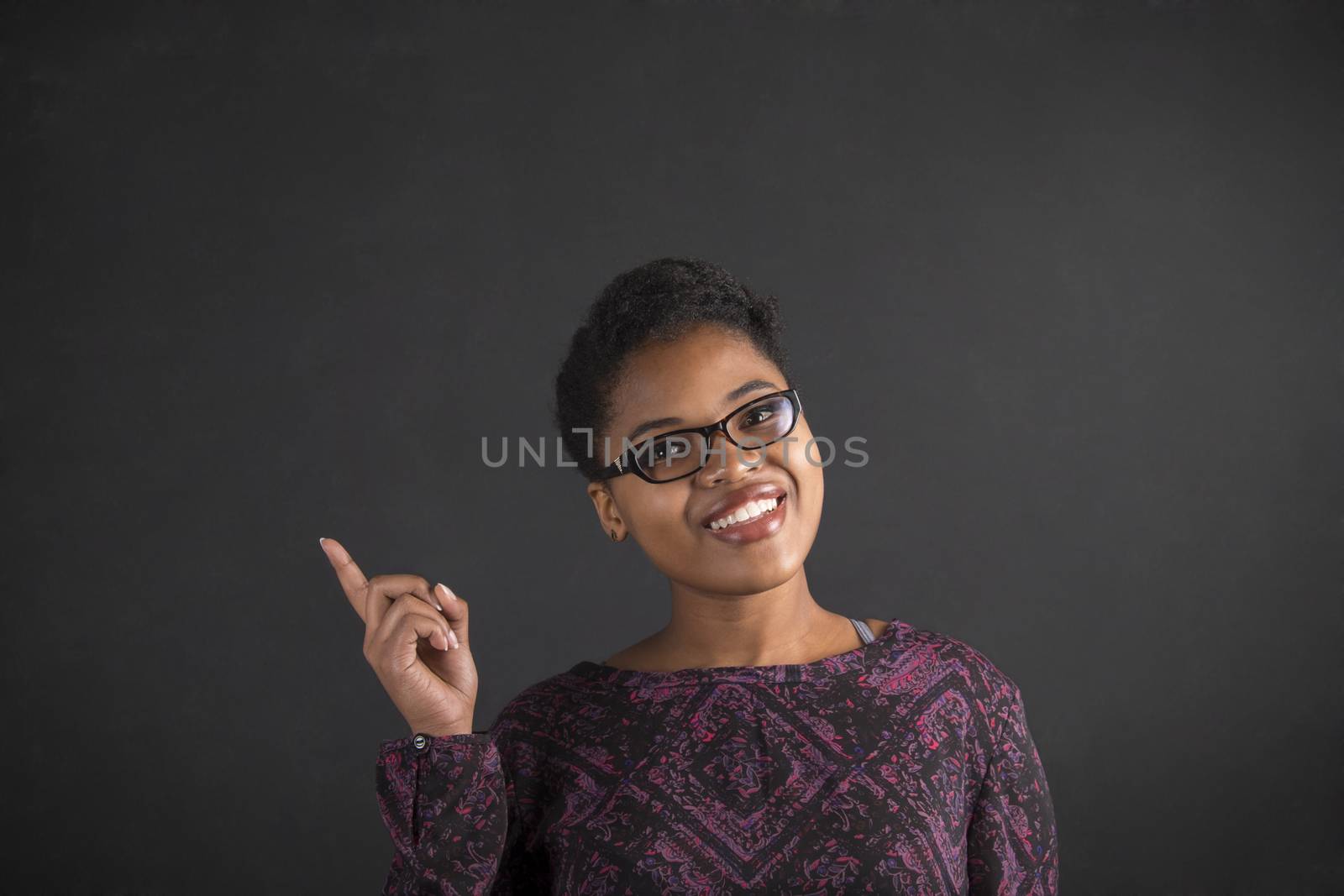 African woman good idea on blackboard background by alistaircotton