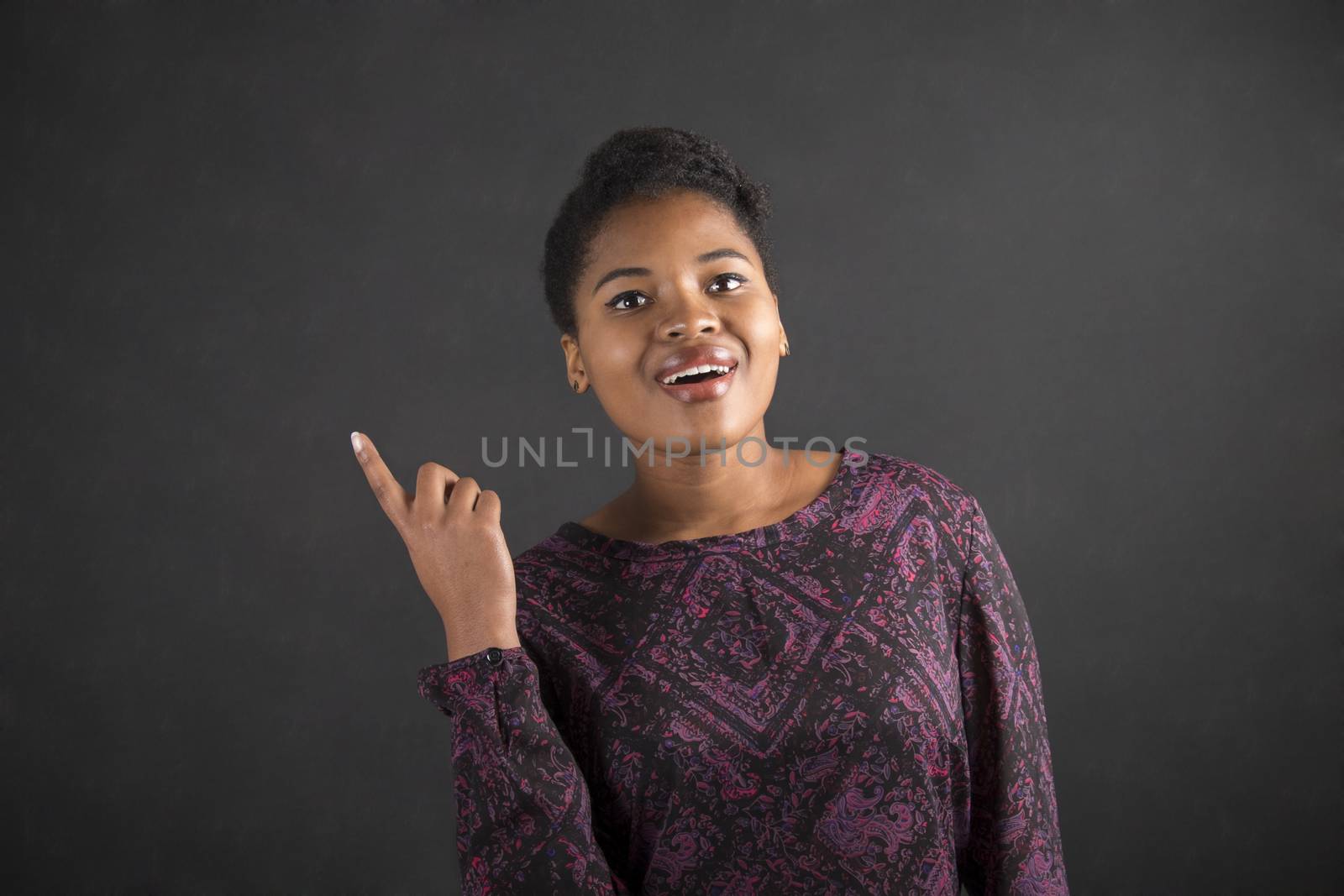 African woman good idea on blackboard background by alistaircotton