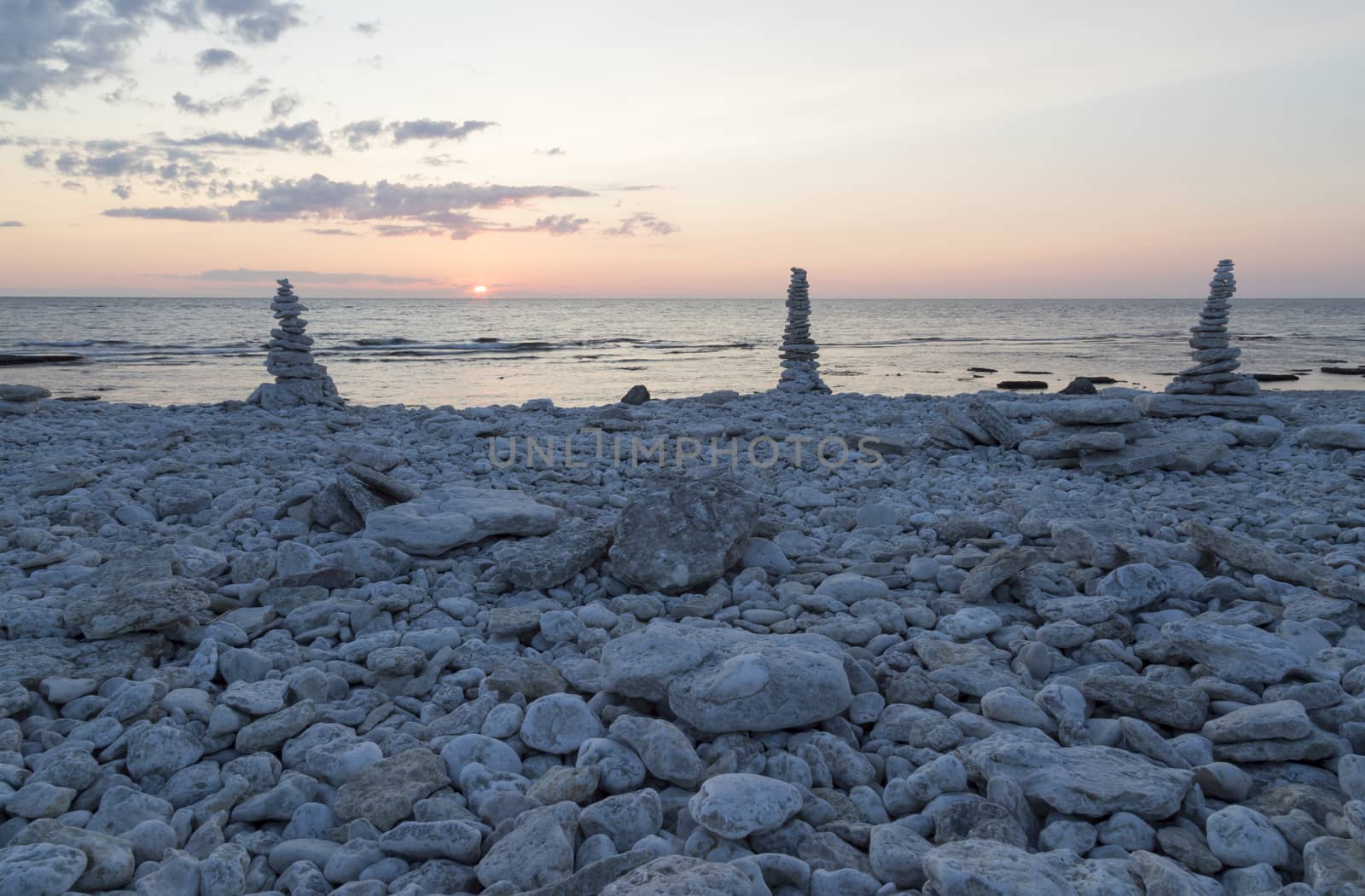 Rocks Piled on Each Other by ocean at sunset.