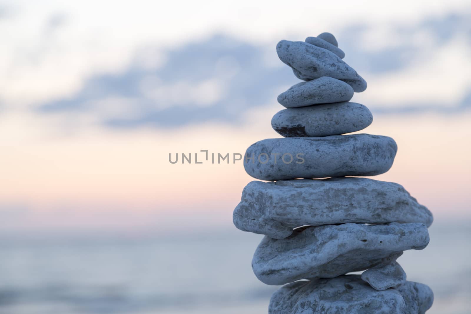 Rocks Piled on Each Other by ocean at sunset.