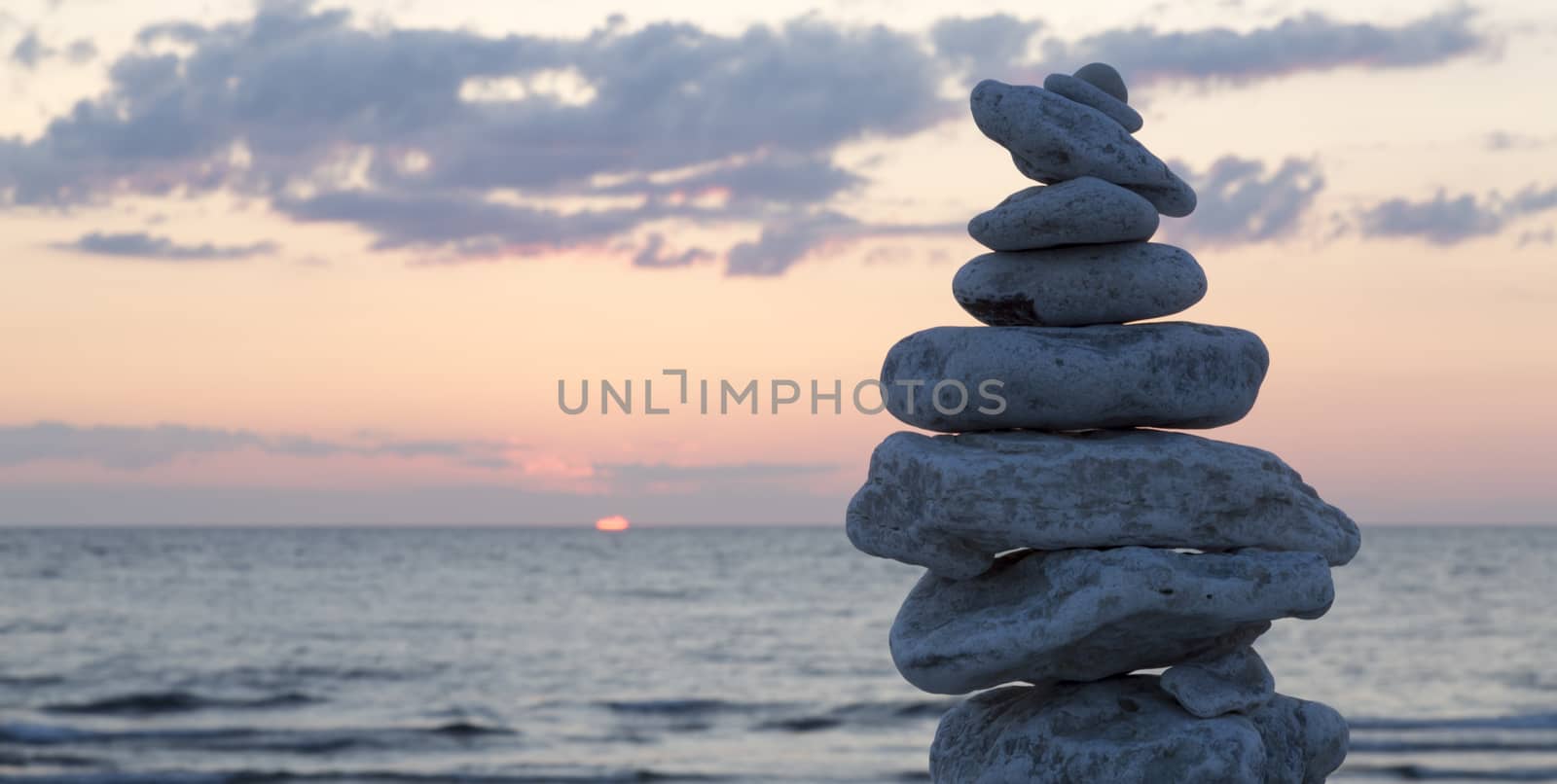 Rocks Piled on Each Other by ocean at sunset.