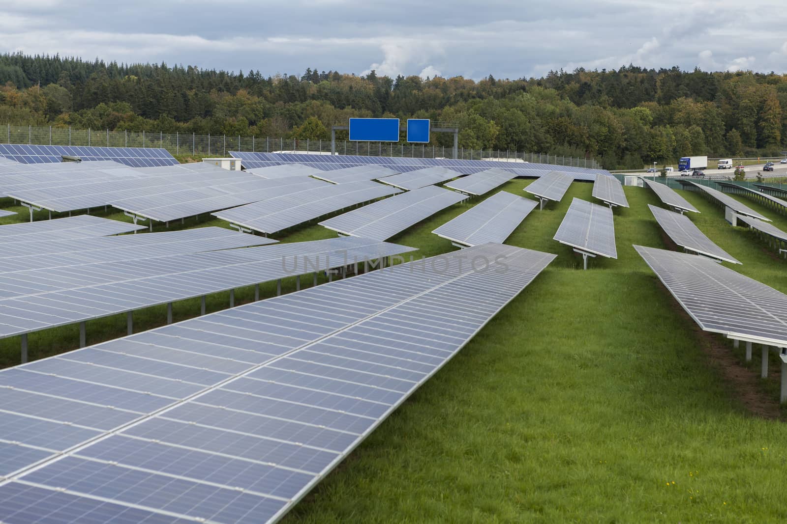 Field with blue siliciom solar cells alternative energy to collect sun energy