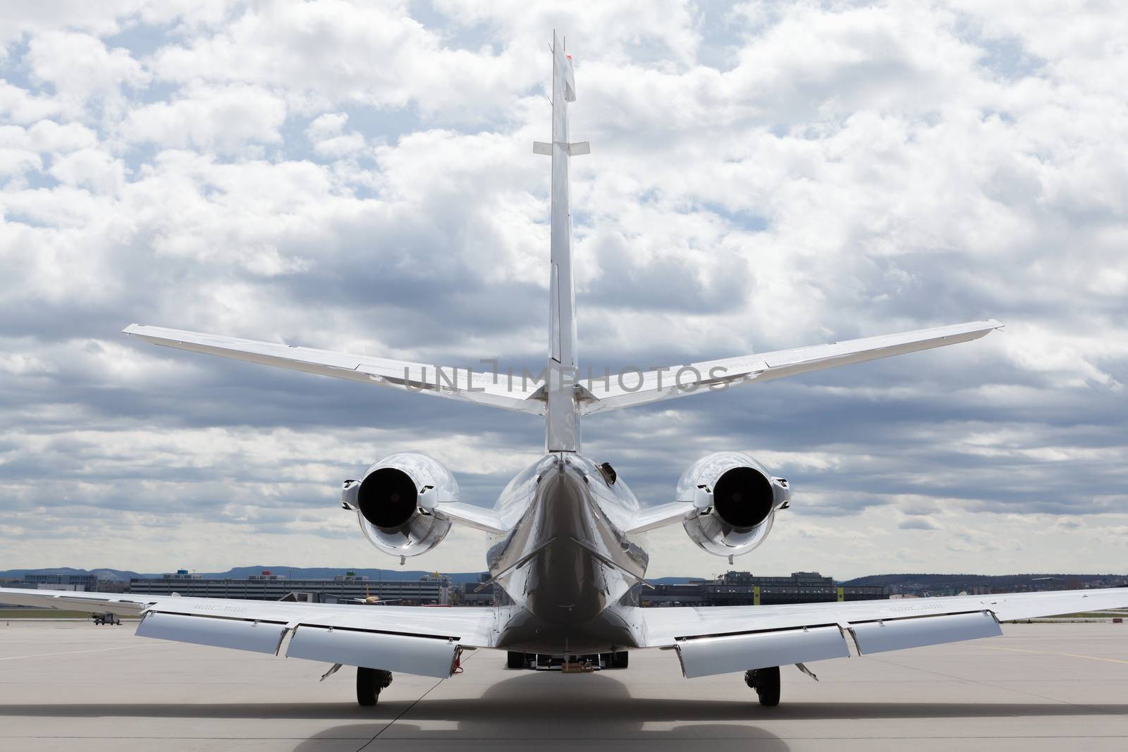 Aircraft learjet Plane in front of the Airport with cloudy sky by juniart