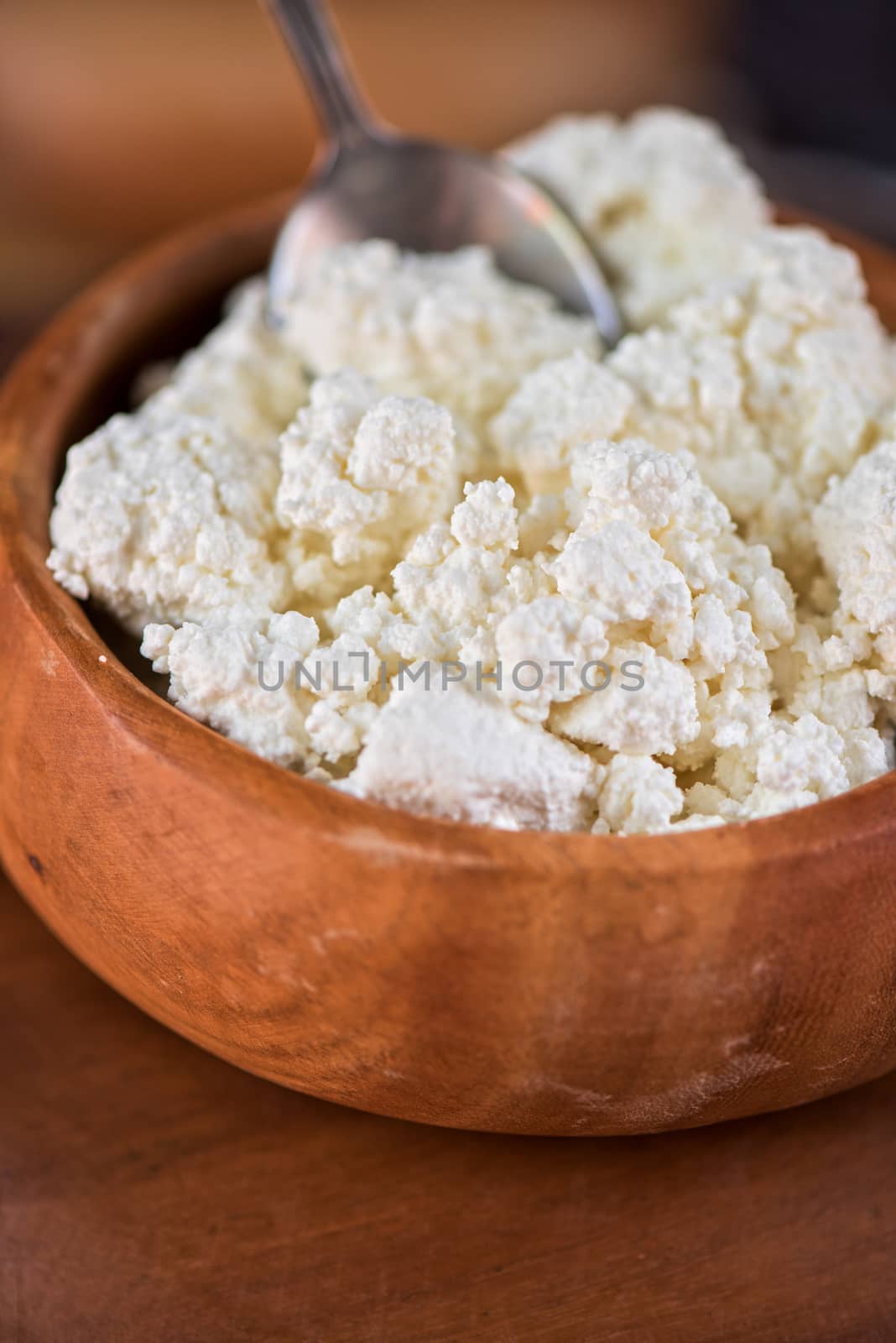curd in brown wooden bowl closeup