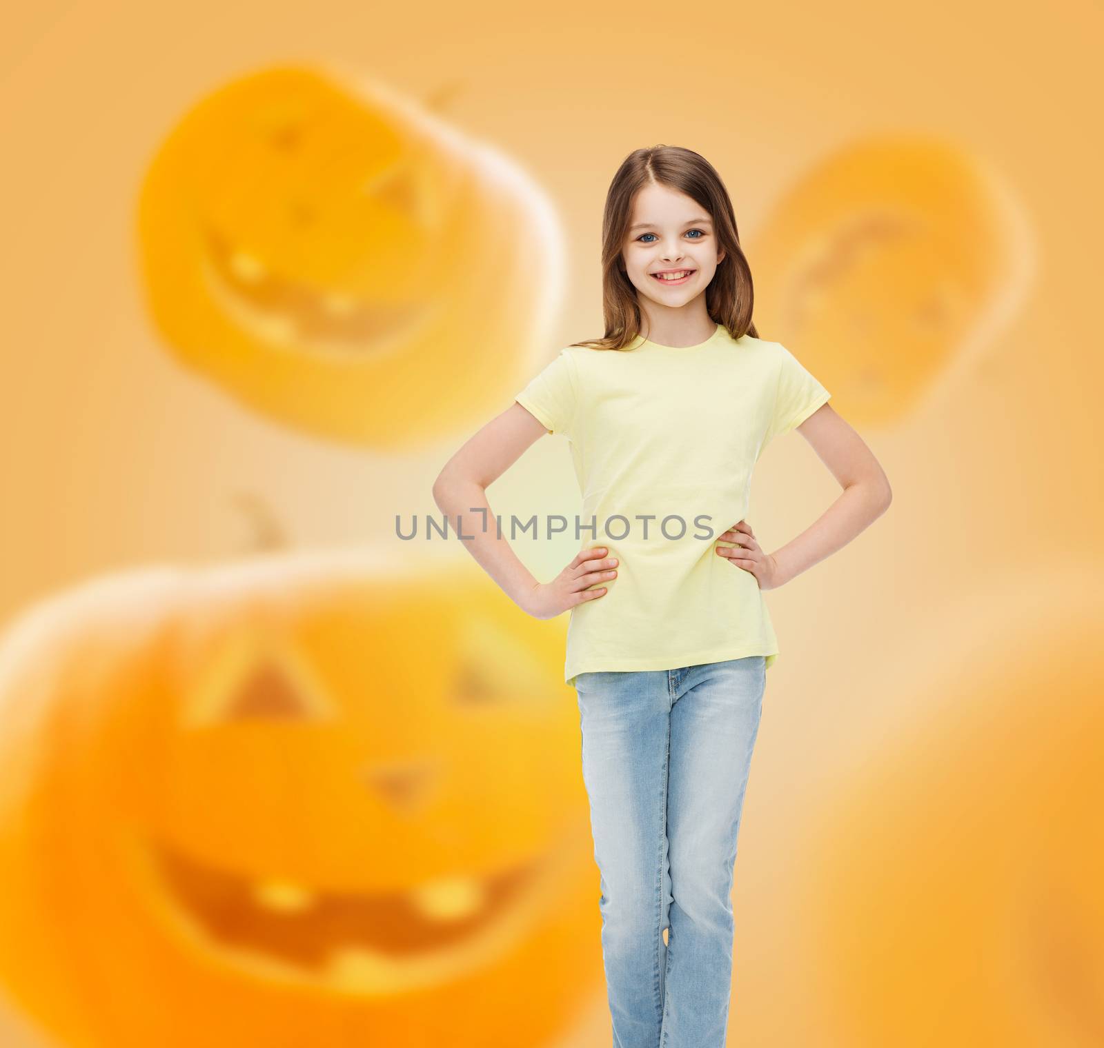 smiling girl over pumpkins background by dolgachov