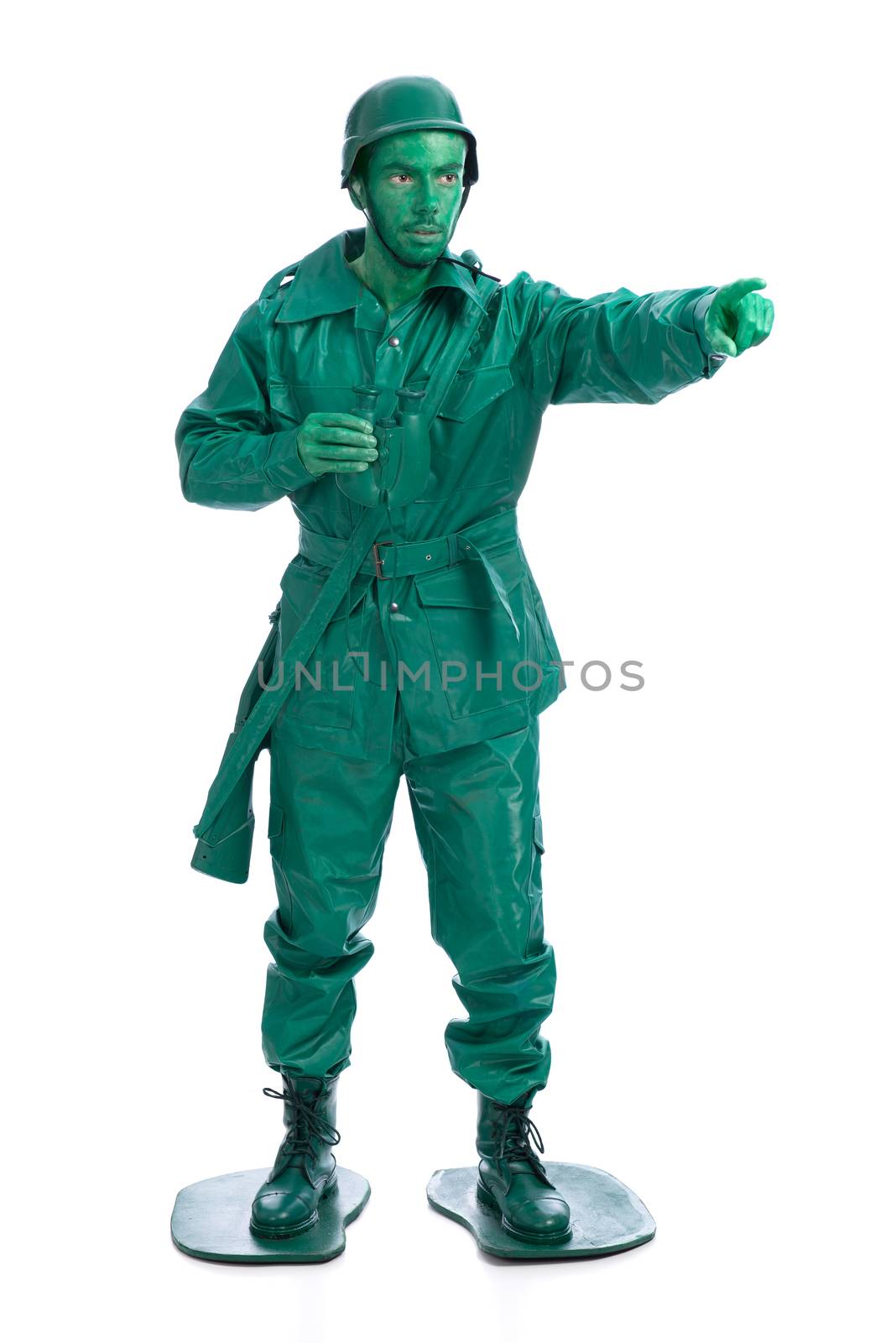 Man on a green toy soldier costume with riffle poiting with his forefinger  isolated on white background.