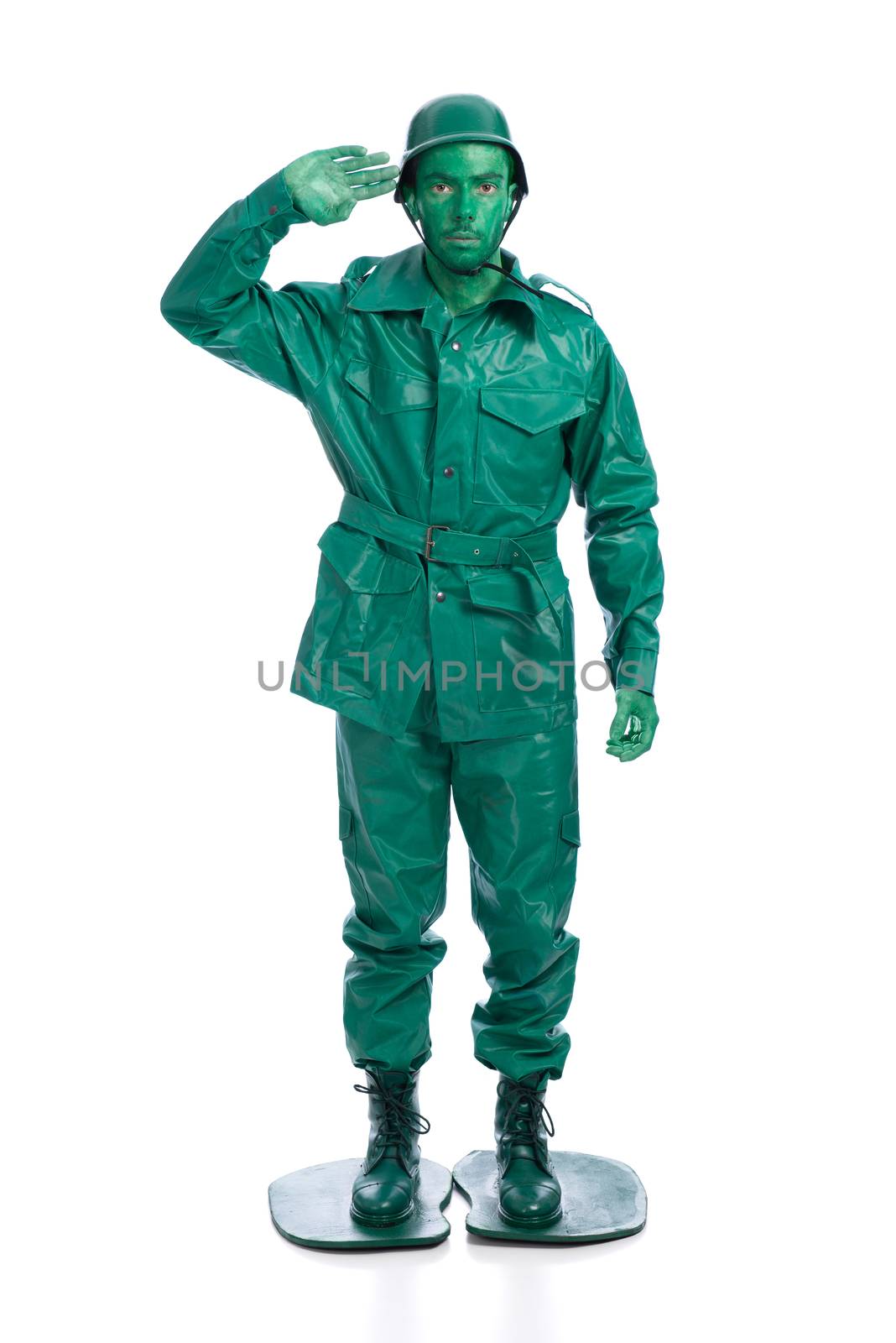 Man on a green toy soldier costume saluting isolated on white background.