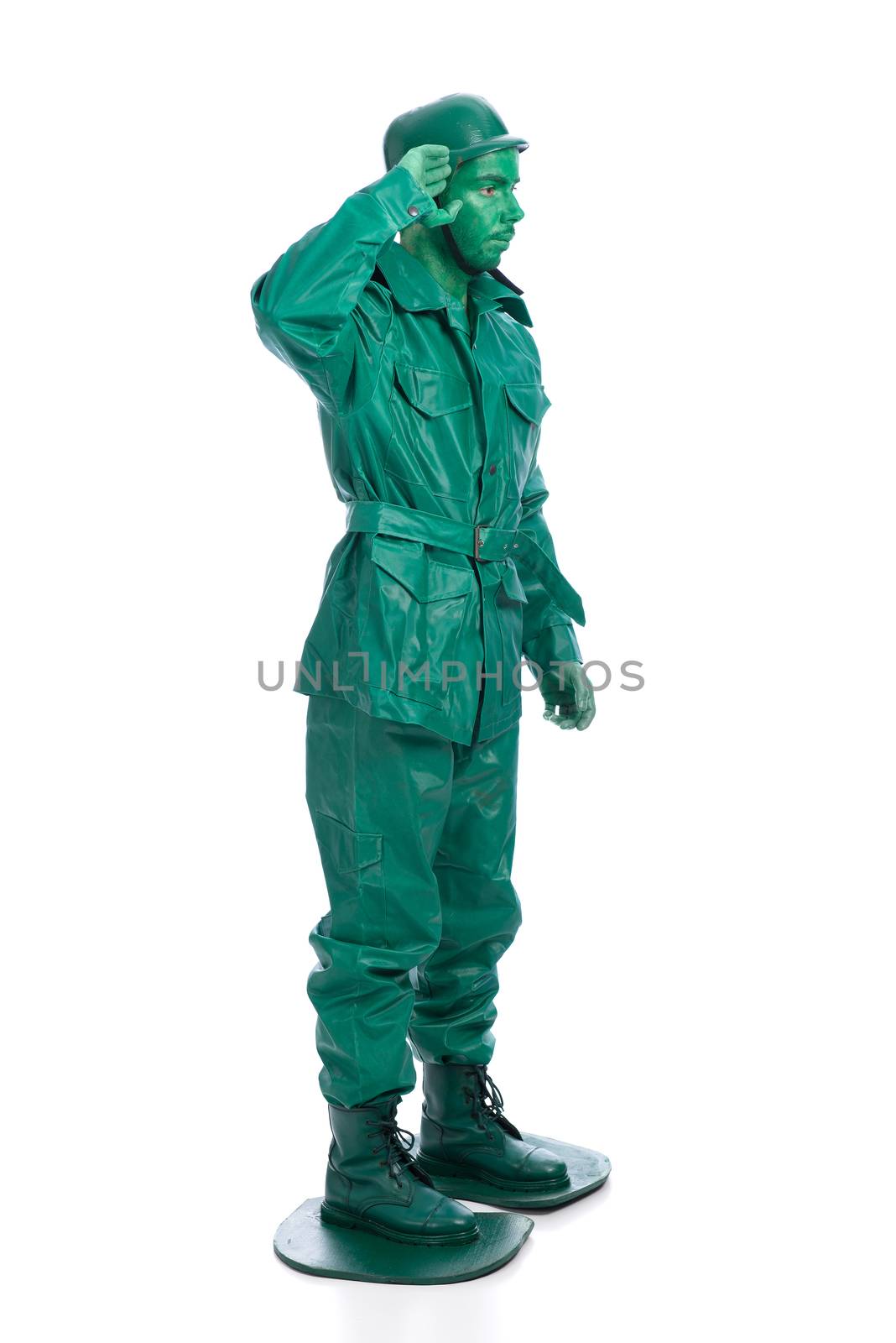 Man on a green toy soldier costume saluting isolated on white background.