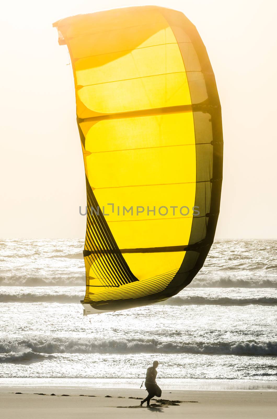 Kitesurfer on a beautiful background of spray during the sunset.