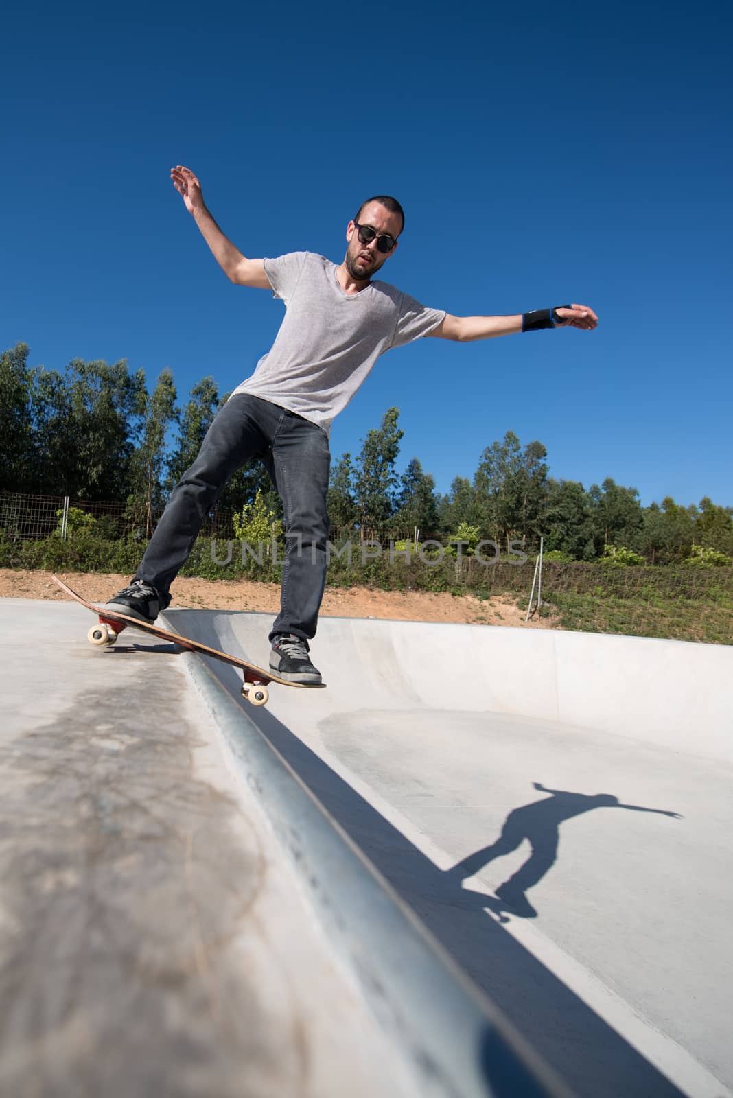 Skateboarder on a slide at the local skatepark.