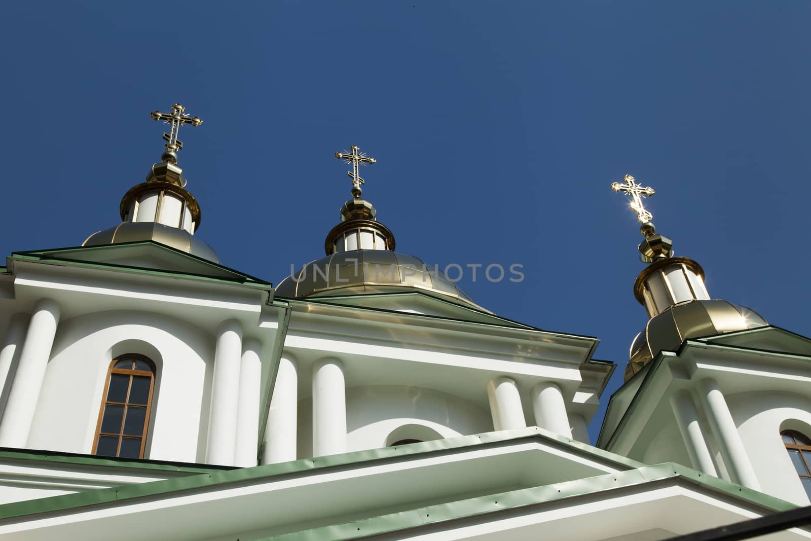 Orthodox church in beams of a bright sun against the blue sky