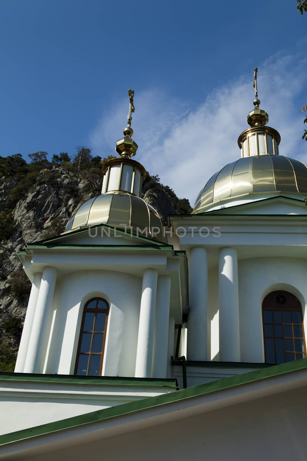 Orthodox church in beams of a bright sun against the blue sky