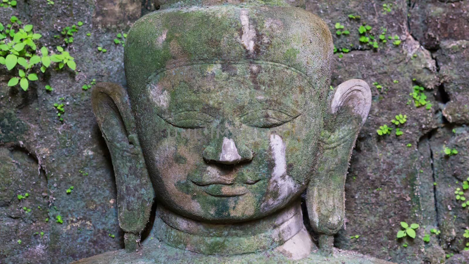 Buddha image at the Koe-thaung Temple, the temple of the 90,000 Buddhas, built by King Min Dikkha during the years 1554-1556 in Mrauk U, Rakhine State in Myanmar. Shallow depth of field with only the face of The Buddha in focus.