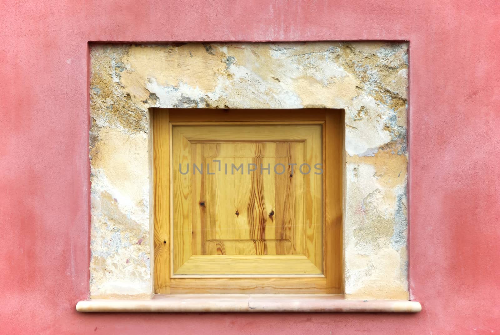 Detail of a Wooden Window on an old pink wall