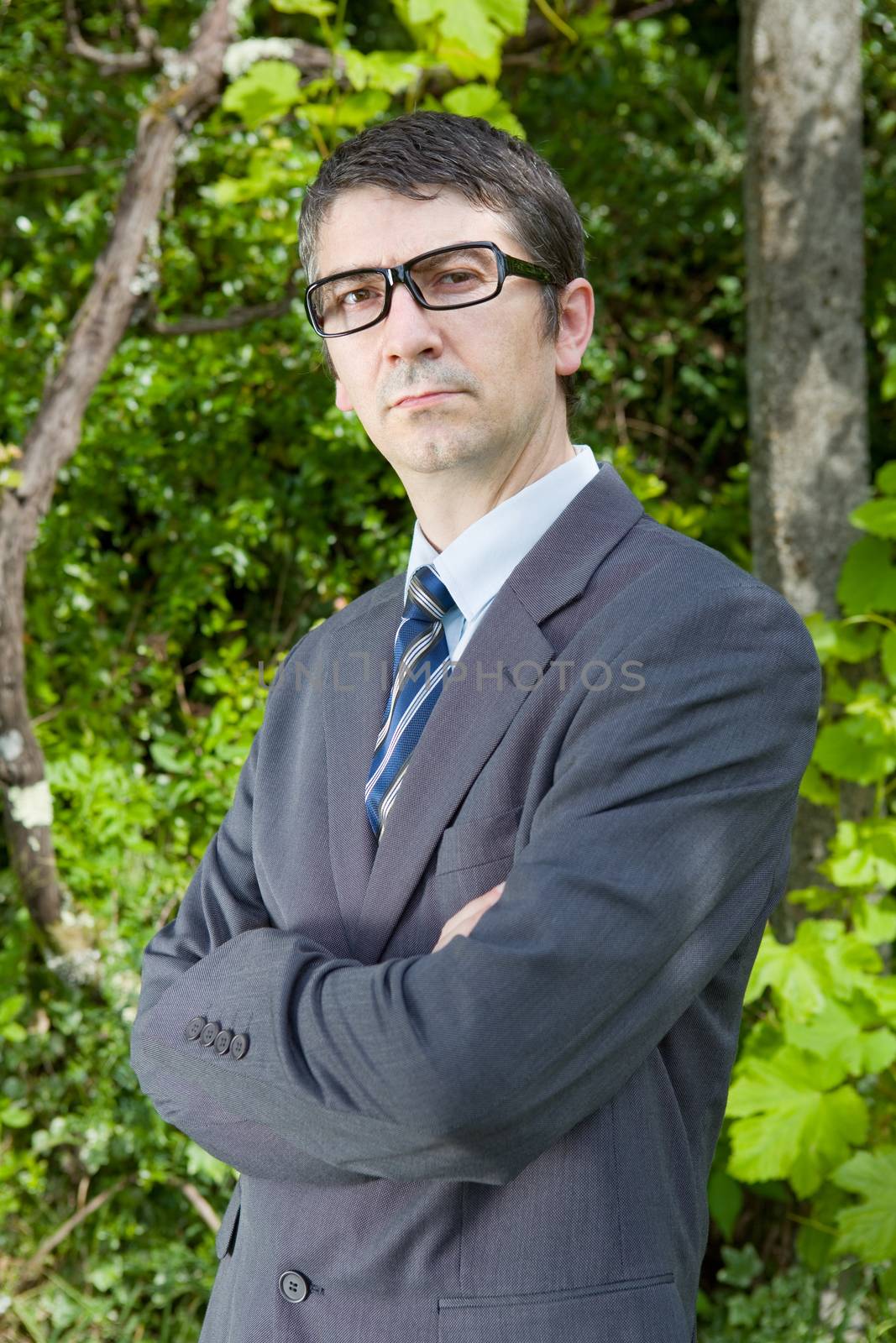 handsome businessman with glasses outdoors