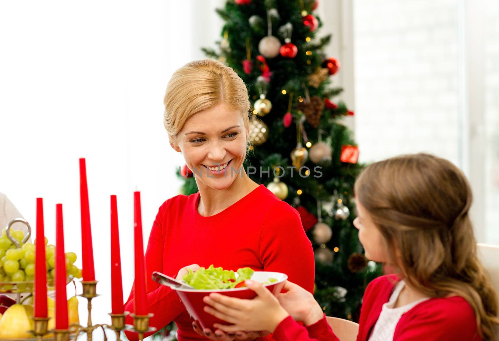 family, holidays, generation, christmas and people concept - smiling family having dinner at home