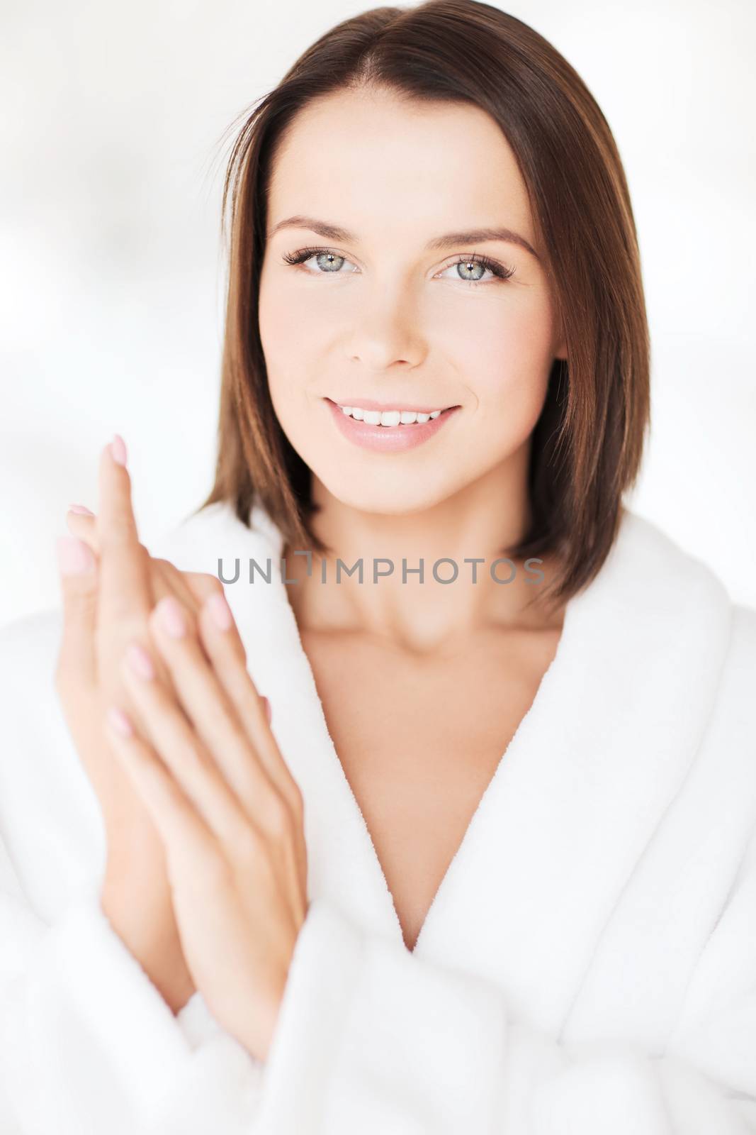 beauty, spa and people concept - beautiful woman in bathrobe