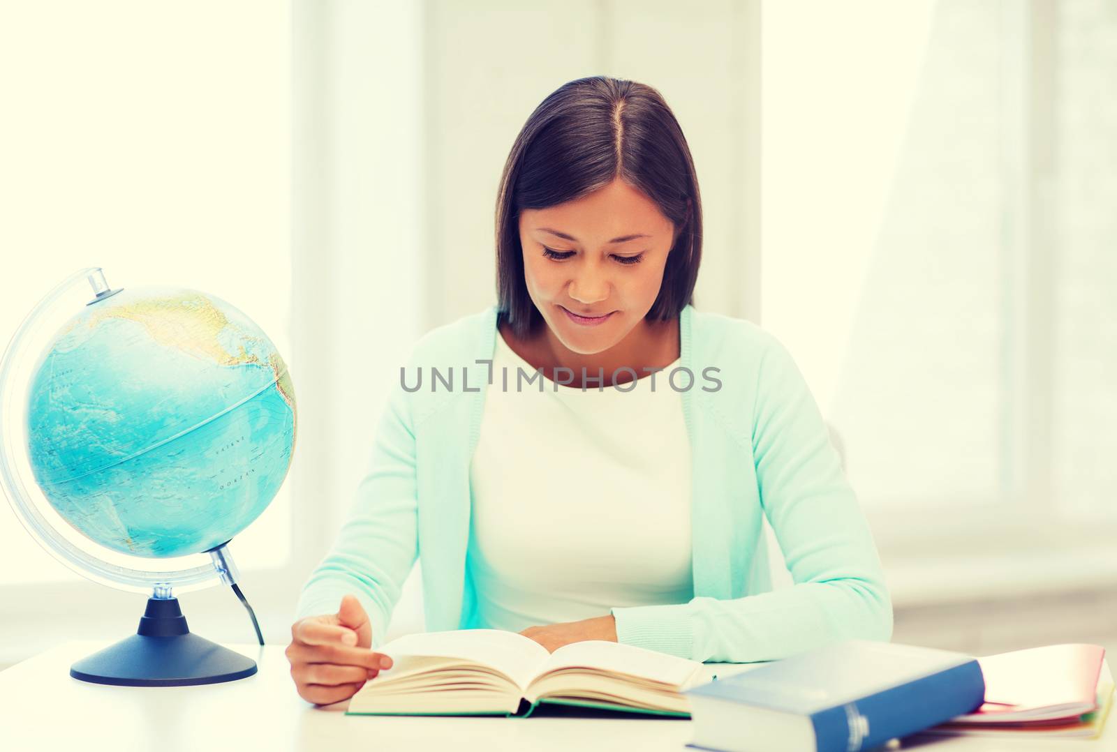 education and school, travel concept - female teacher with globe and book