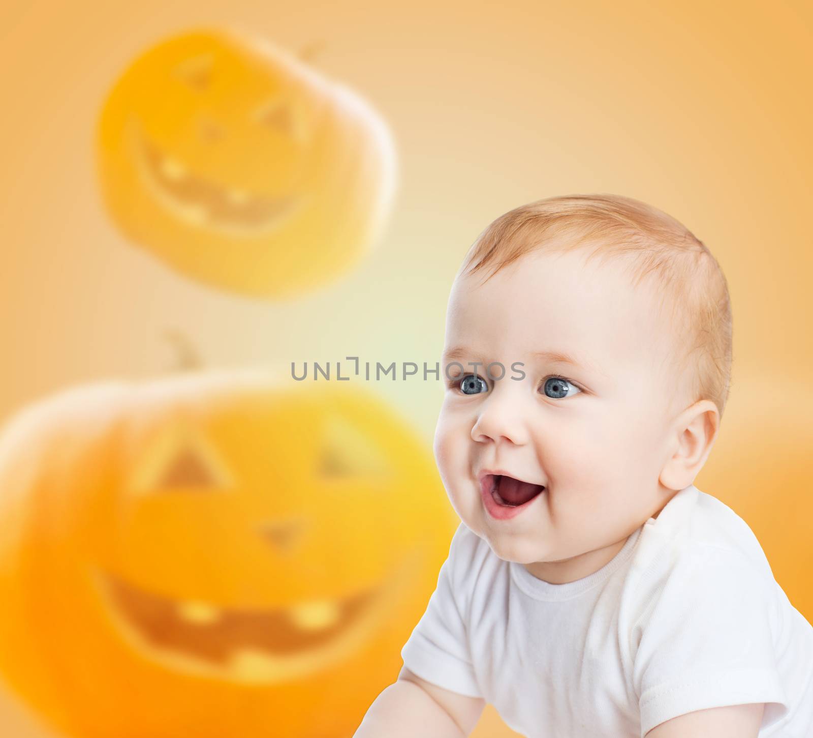 smiling baby over pumpkins background by dolgachov