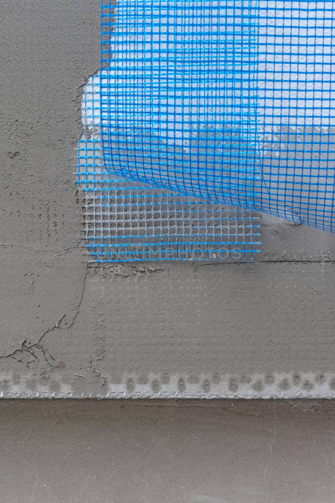 Polystyrene insulation boards covered with mesh covered and mortar over old wall surface