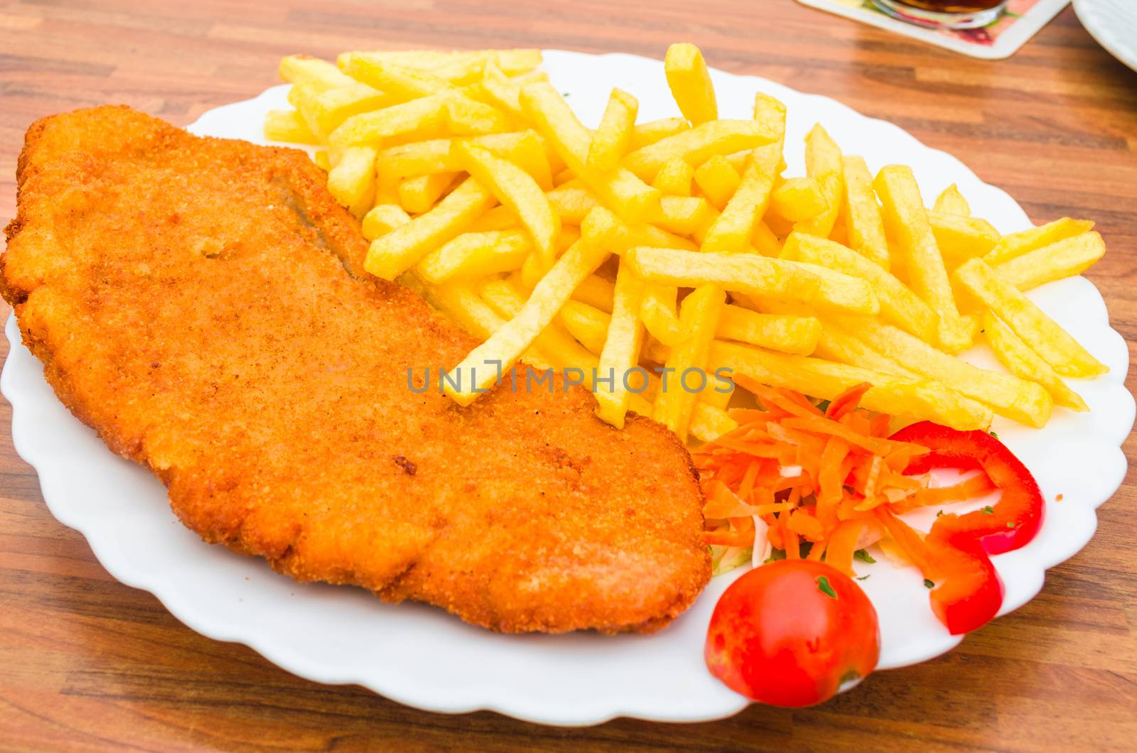 Wiener schnitzel, breaded steak with French fries and lemon
