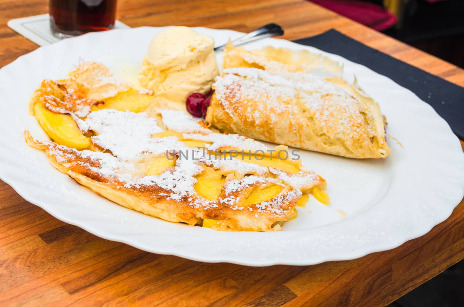 Egg pancake with apple on a plate in a restaurant