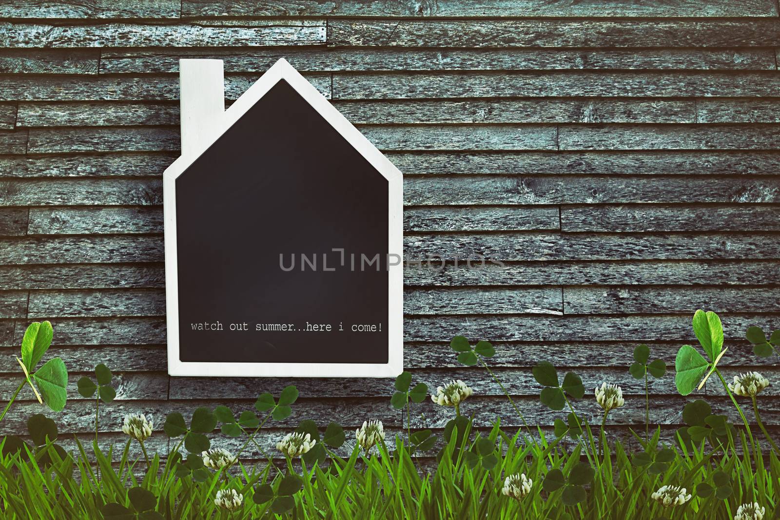 House shaped chalkboard on wooden background by Sandralise