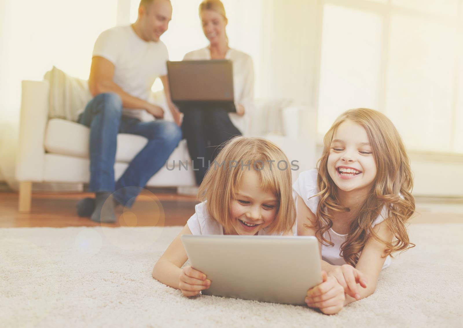 smiling sister with tablet pc and parents on back by dolgachov