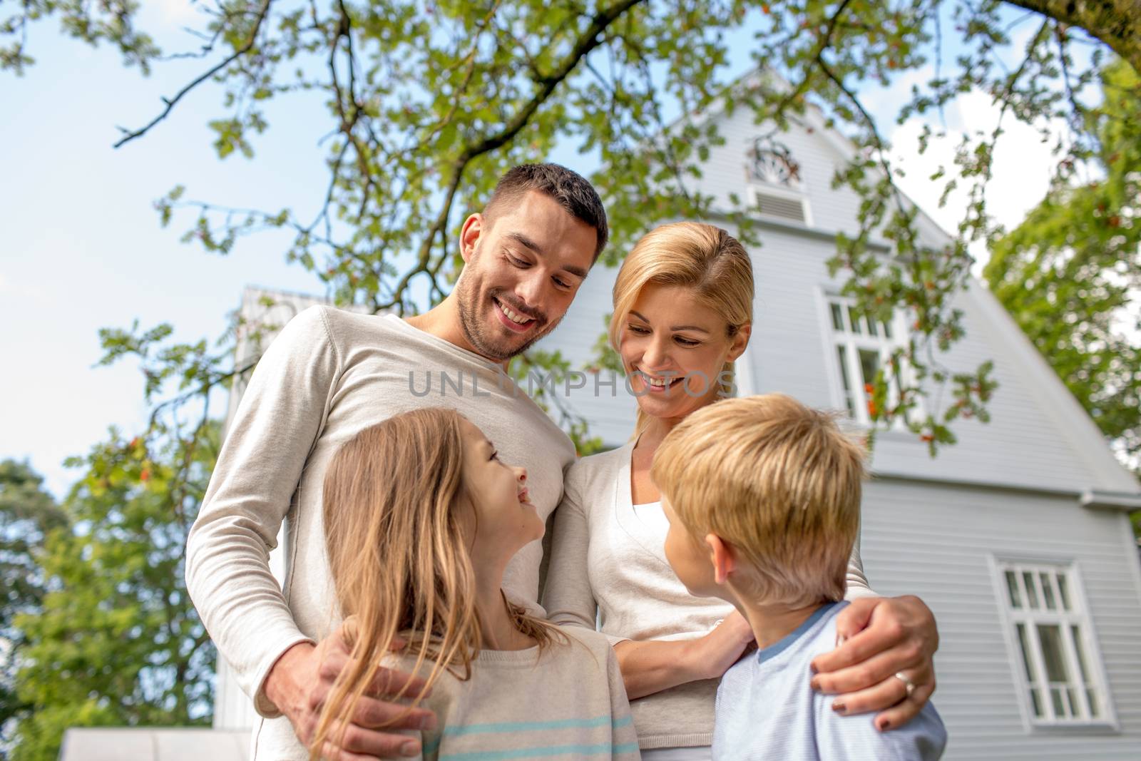 family, happiness, generation, home and people concept - happy family standing in front of house outdoors