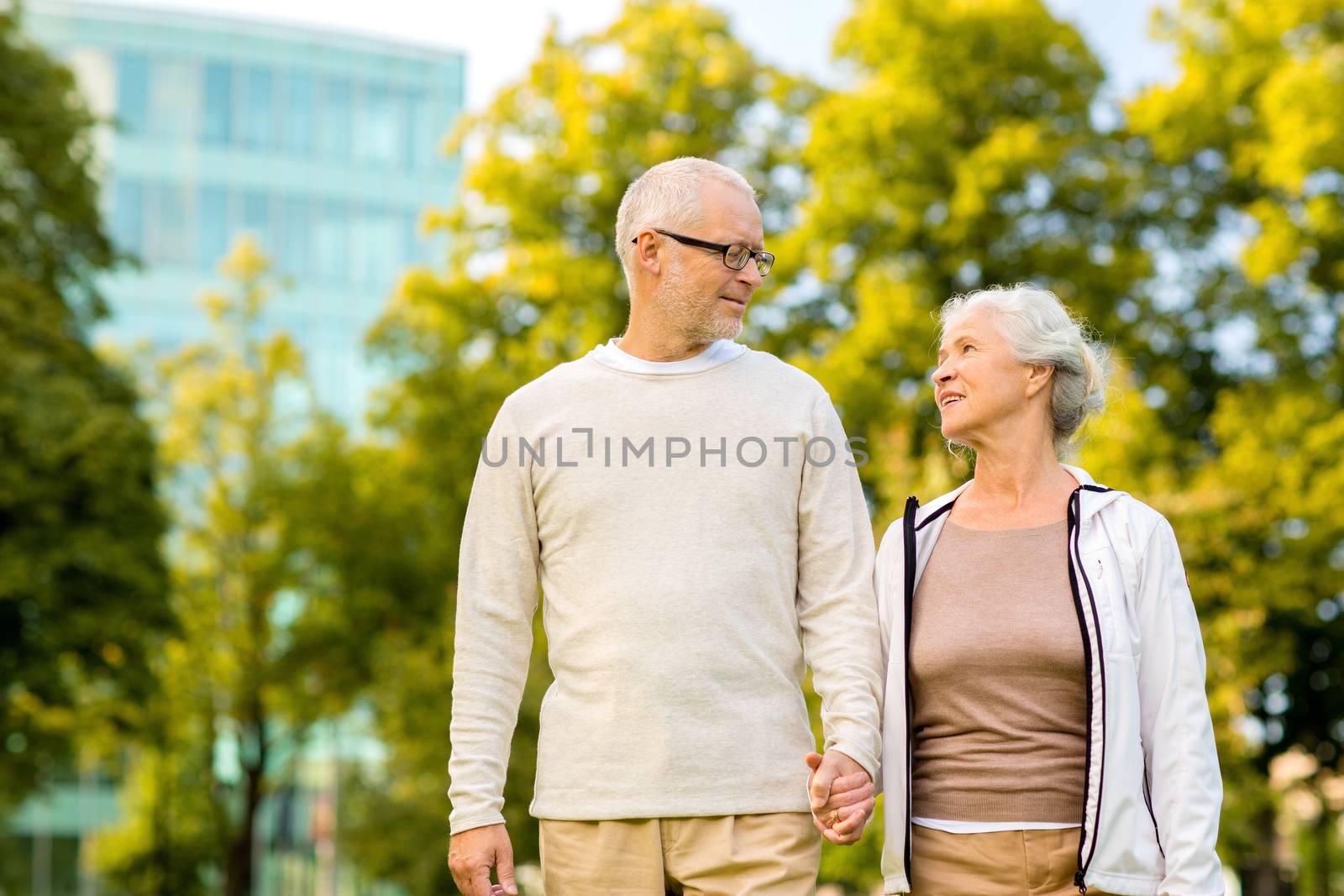 senior couple in city park by dolgachov