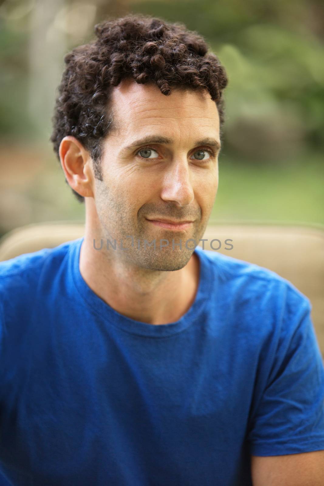 Single confident adult in blue shirt with grin