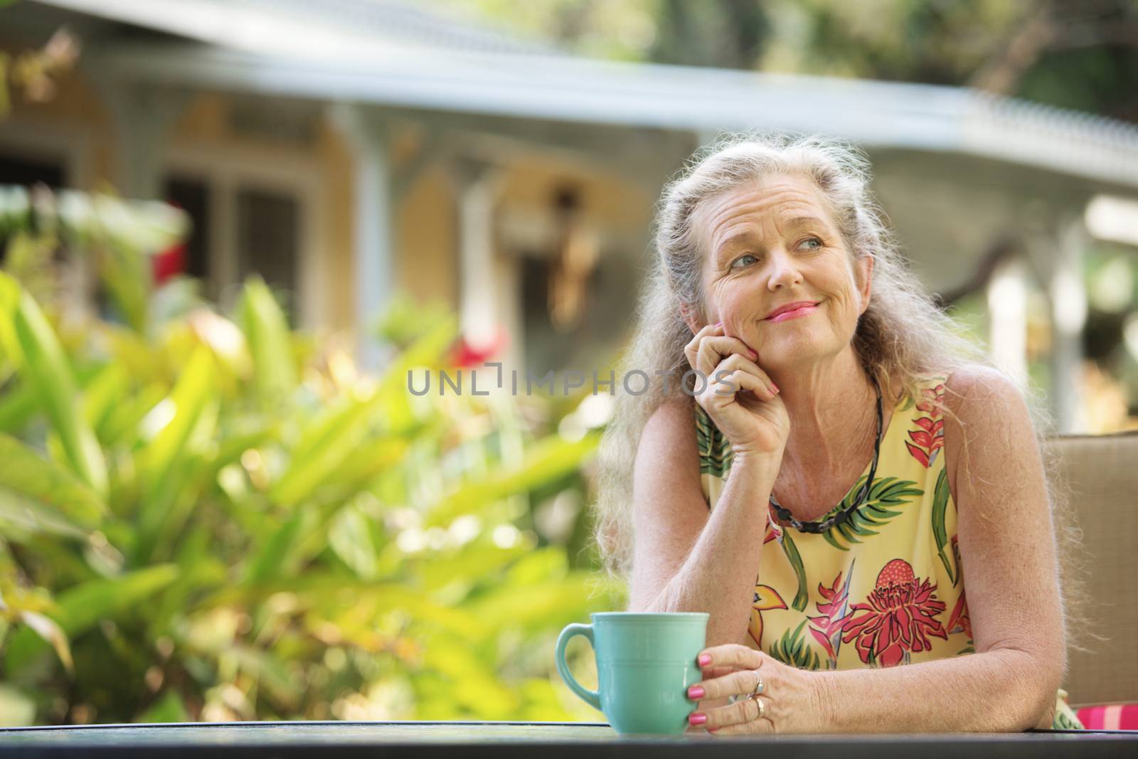 Cute single mature woman with hand on chin