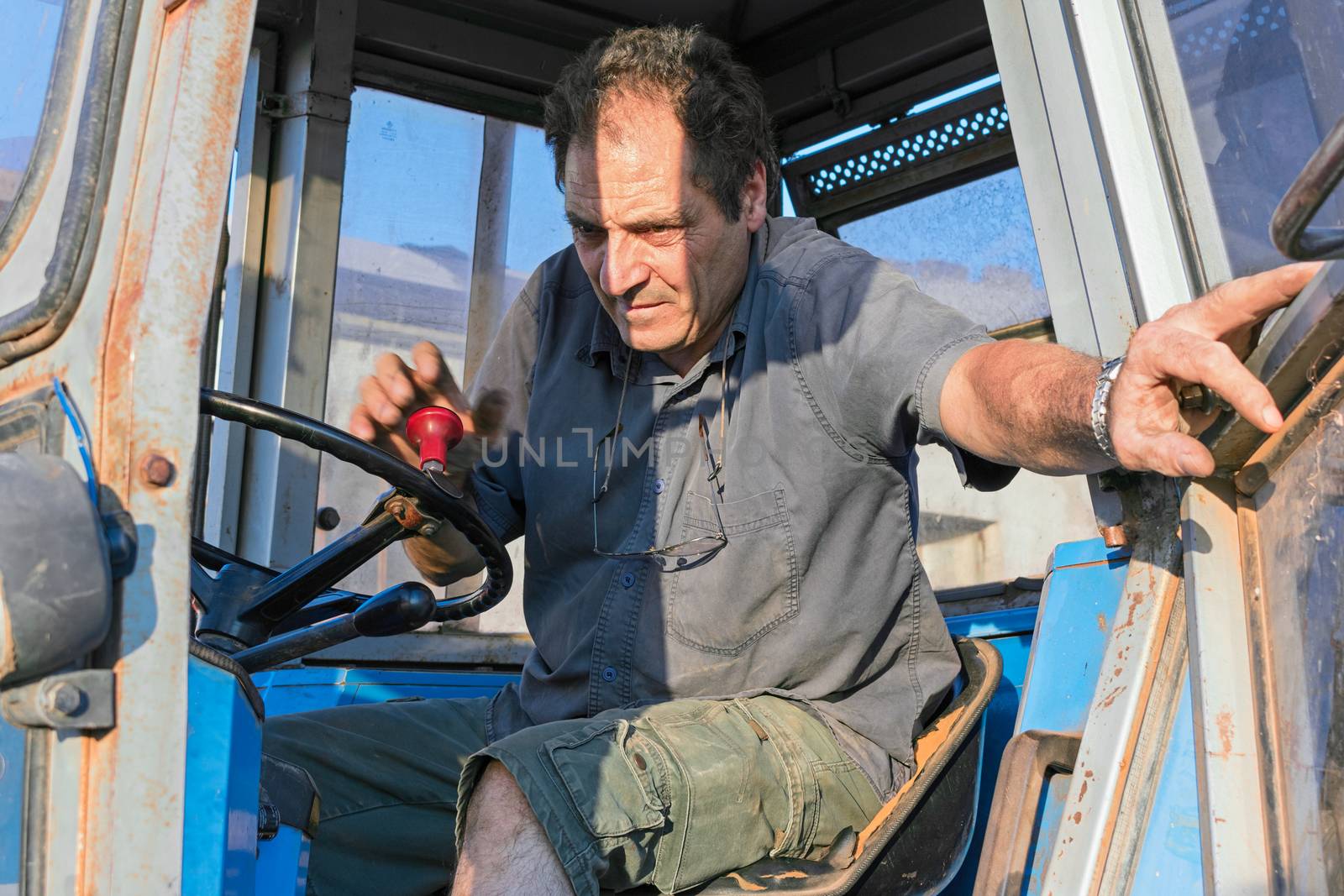 man on farm tractor by EnzoArt