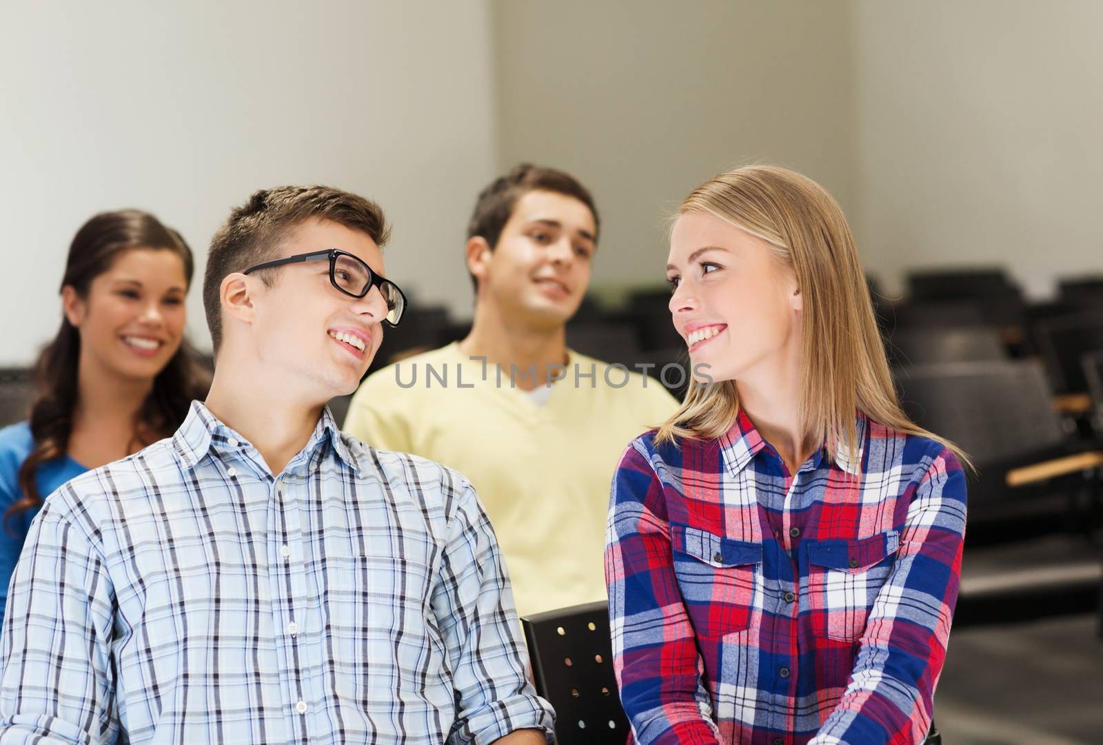 group of smiling students in lecture hall by dolgachov