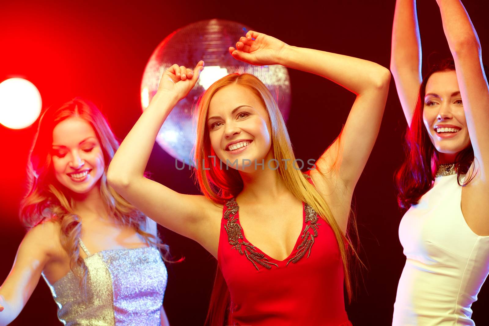 party, new year, celebration, friends, bachelorette party, birthday concept - three beautiful women in evening dresses dancing in the club