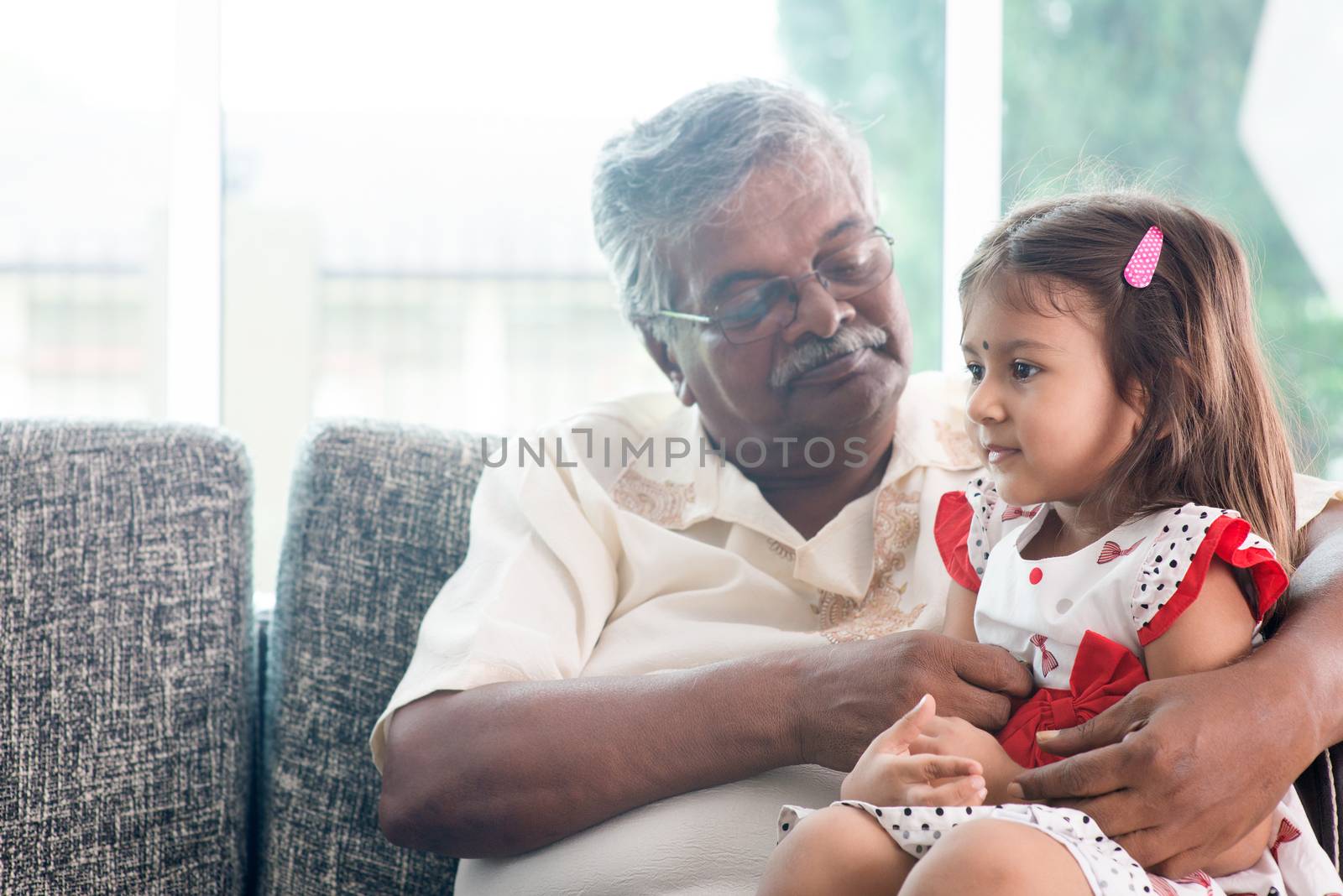 Portrait Indian family at home. Grandparent and grandchild playing together. Asian people living lifestyle. Grandfather and granddaughter.