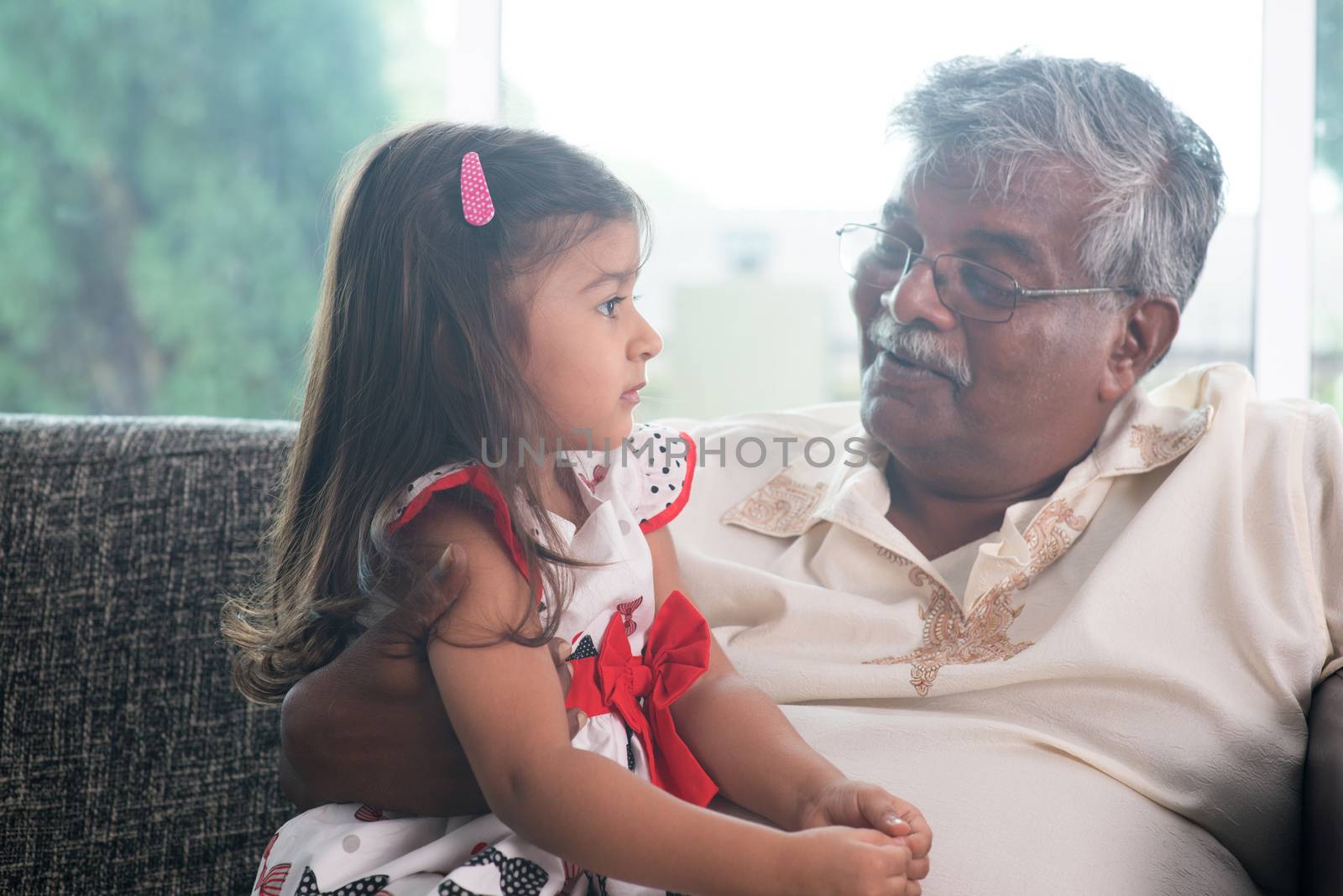 Portrait Indian family at home. Grandparent and grandchild talking together. Asian people living lifestyle. Grandfather and granddaughter.