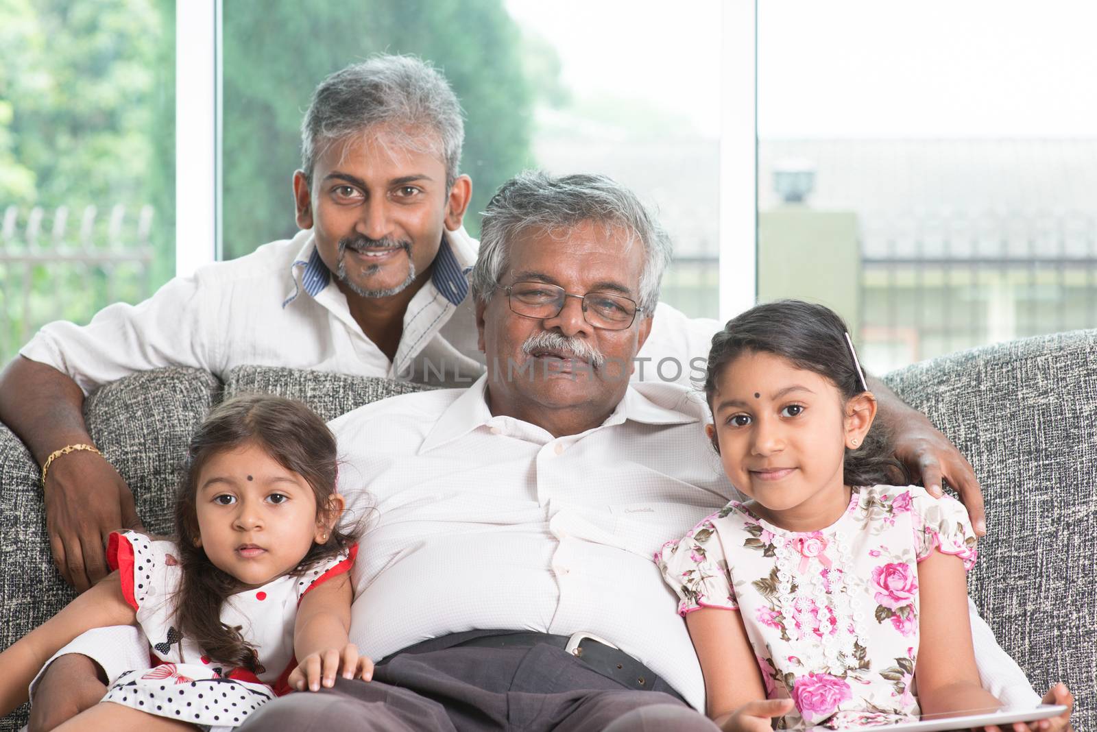 Portrait of multi generations Indian family at home. Asian people living lifestyle.