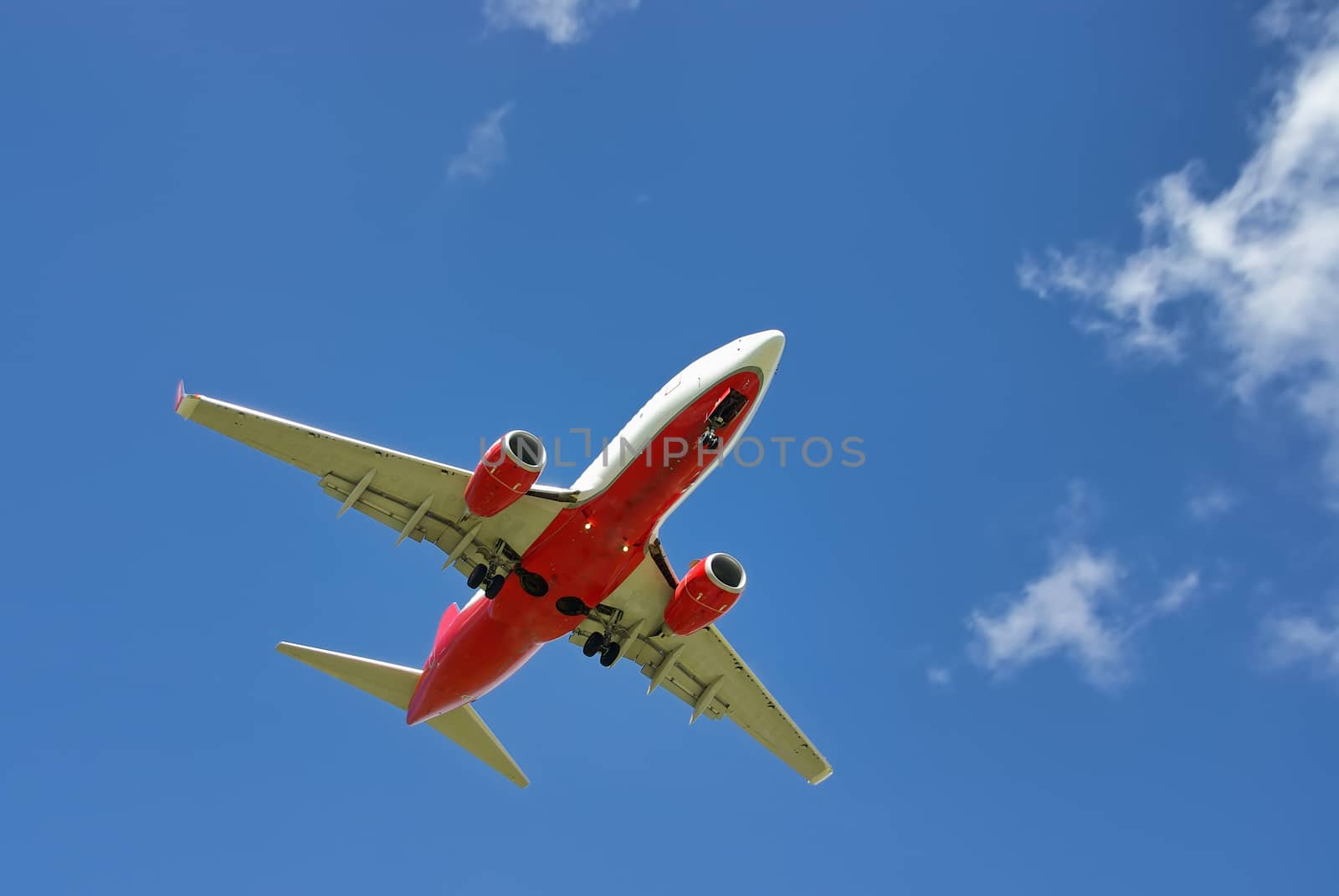 White and Red passenger aircraft landing in Spain on the summer season