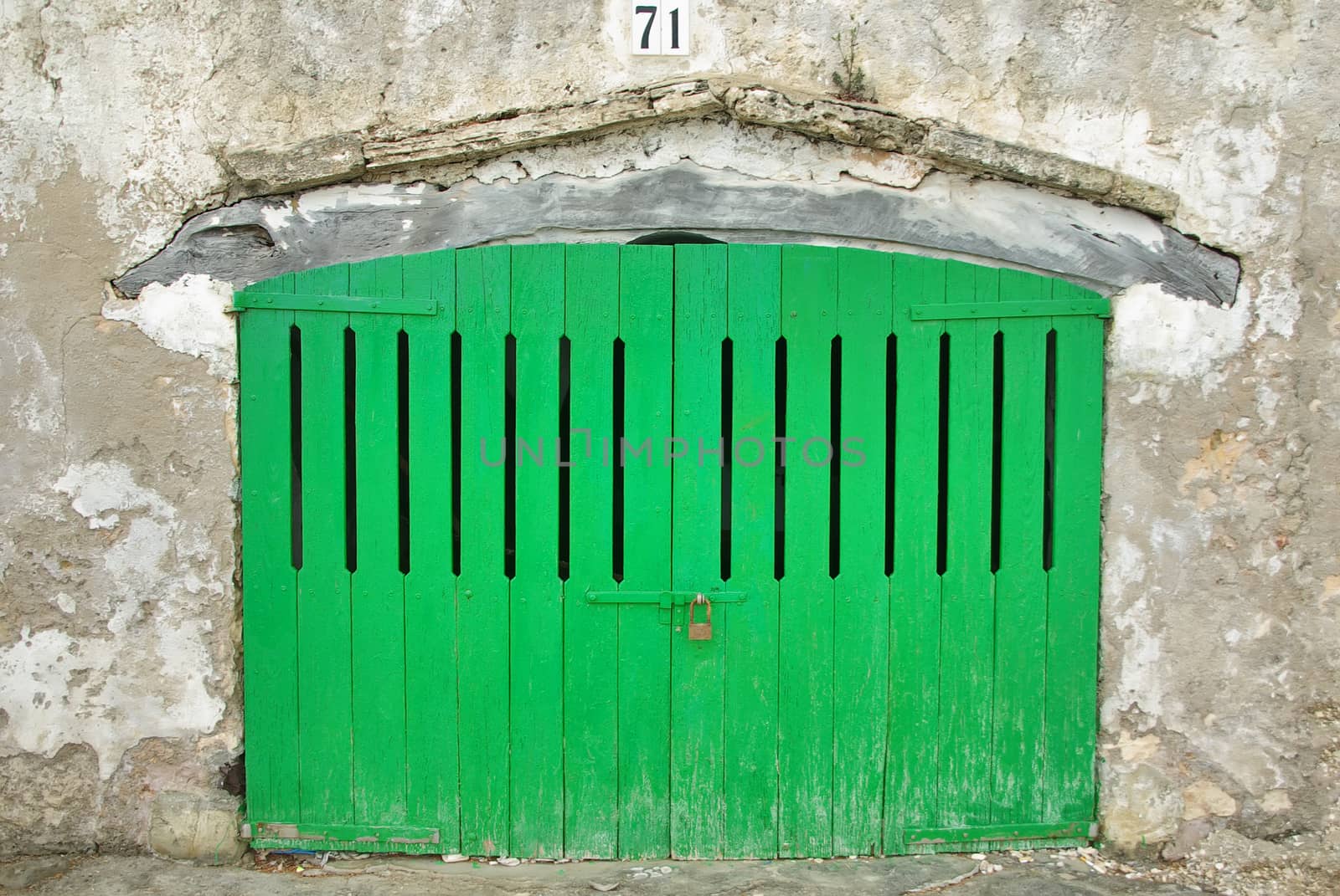 Wooden green door of a boat shelter in Majorca