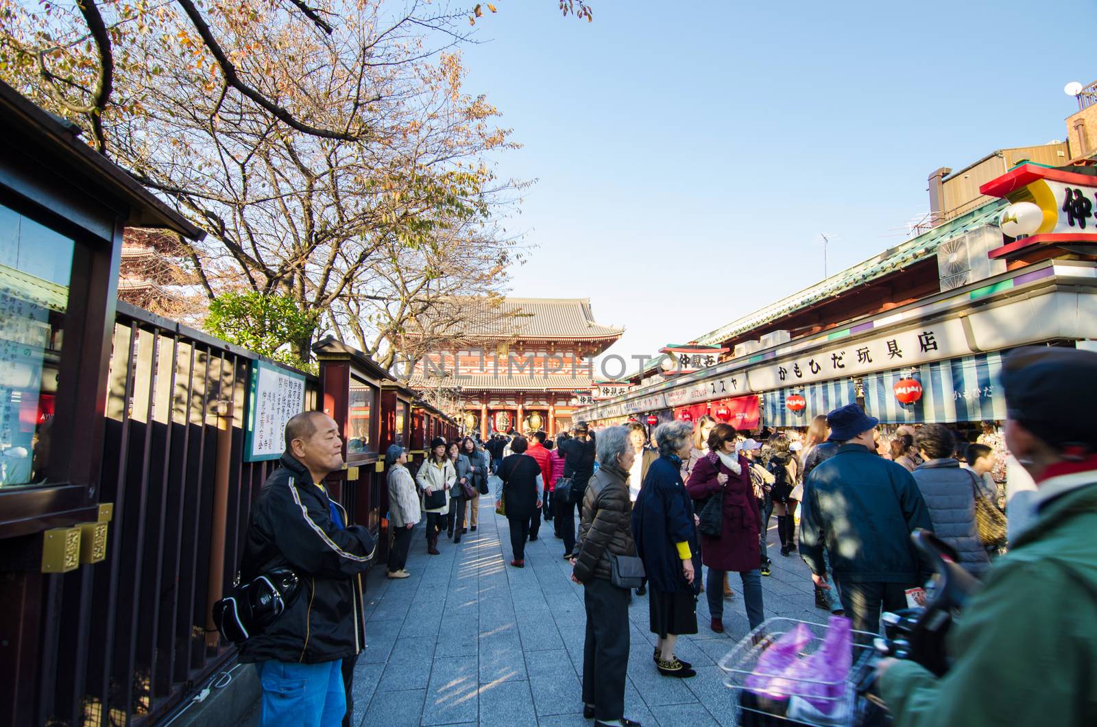 Tokyo, Japan - November 21, 2013: Tourists Shopping at Nakamise  by siraanamwong