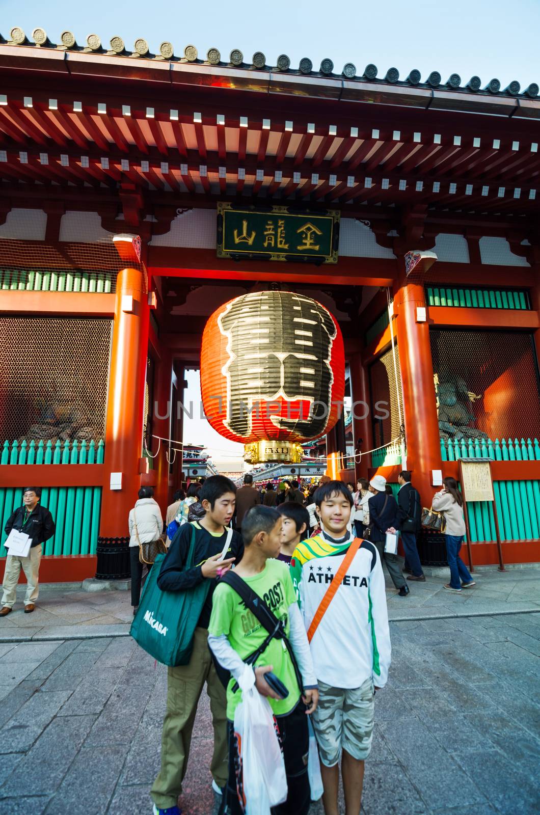 Tokyo, Japan - November 21, 2013: Tourists at the entrance of Sensoji temple. by siraanamwong