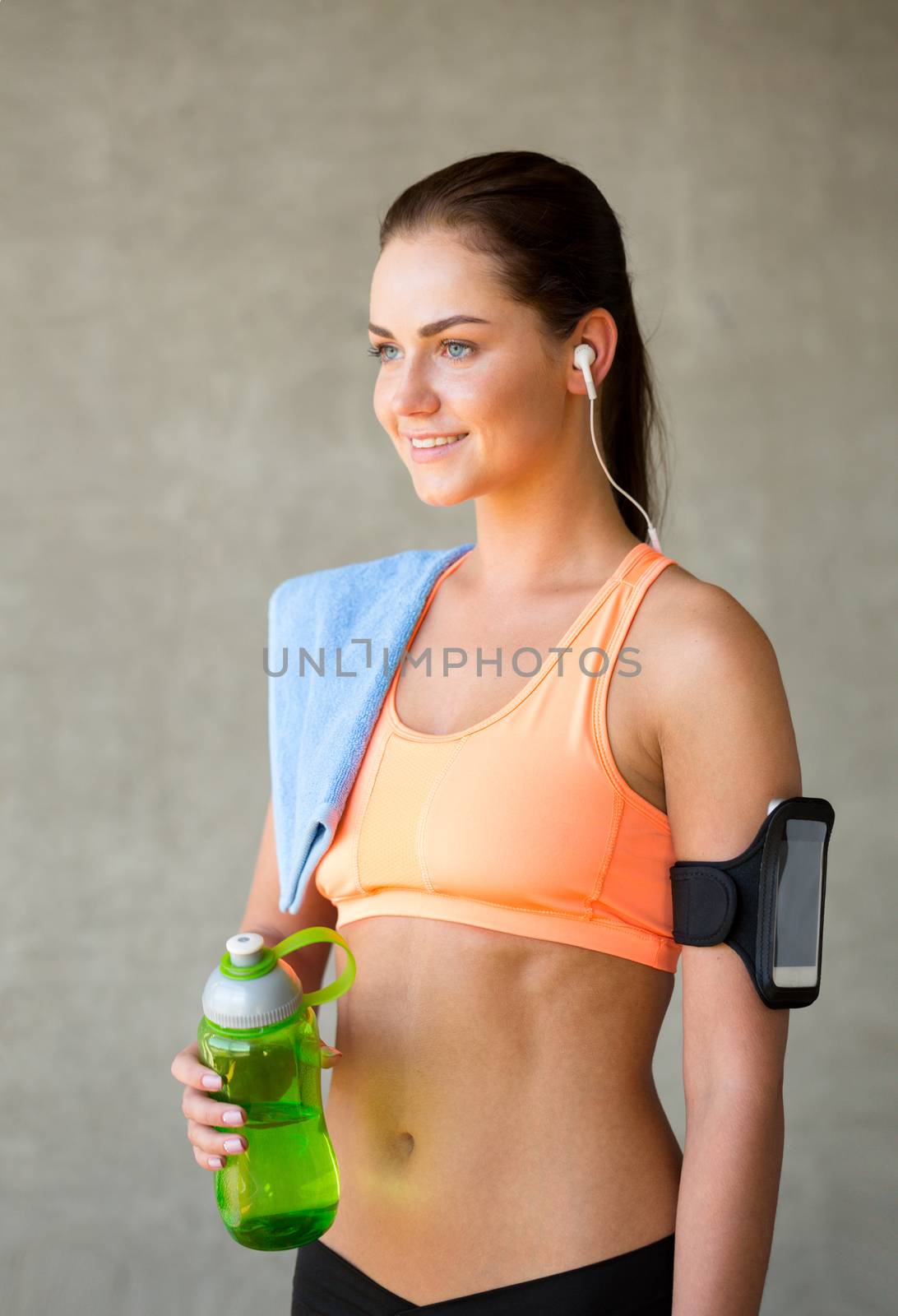 woman with bottle of water in gym by dolgachov