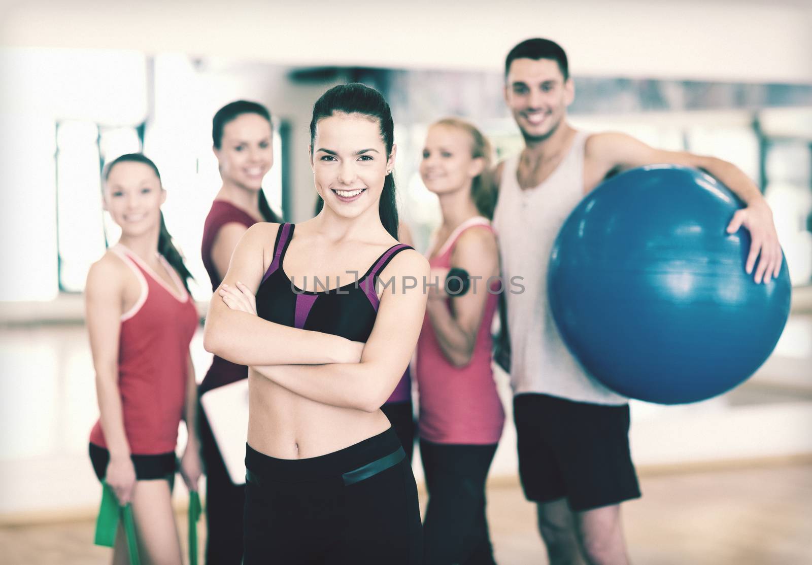 woman standing in front of the group in gym by dolgachov