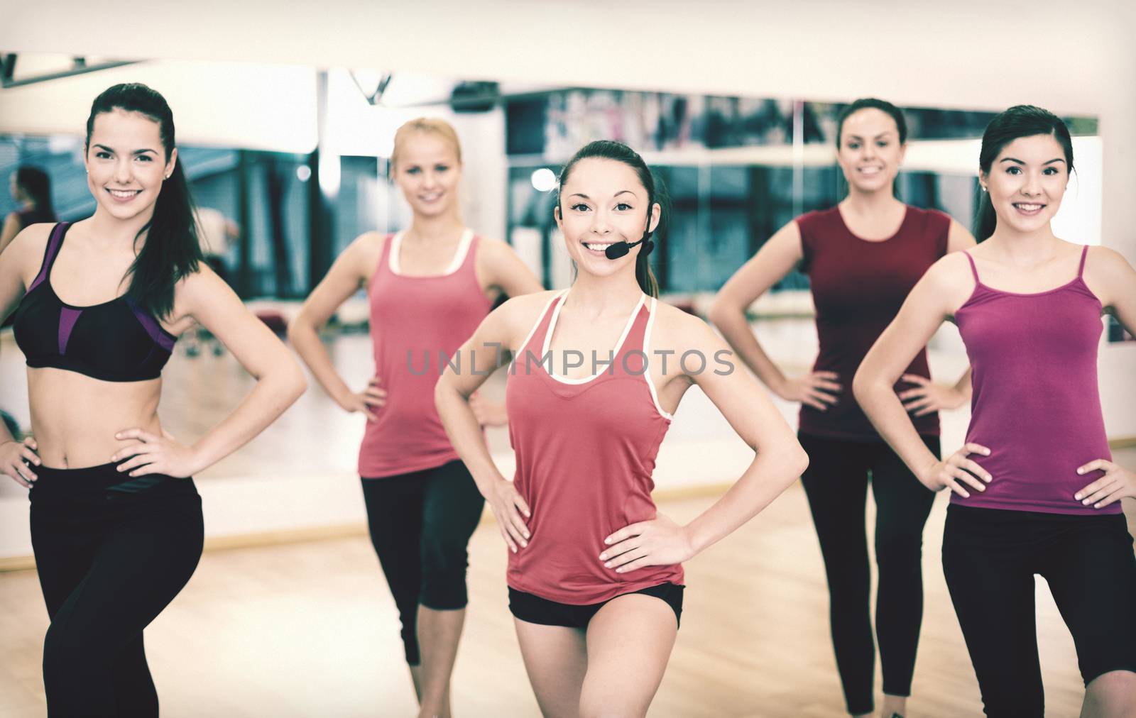 fitness, sport, training, gym and lifestyle concept - group of smiling people with trainer exercising in the gym