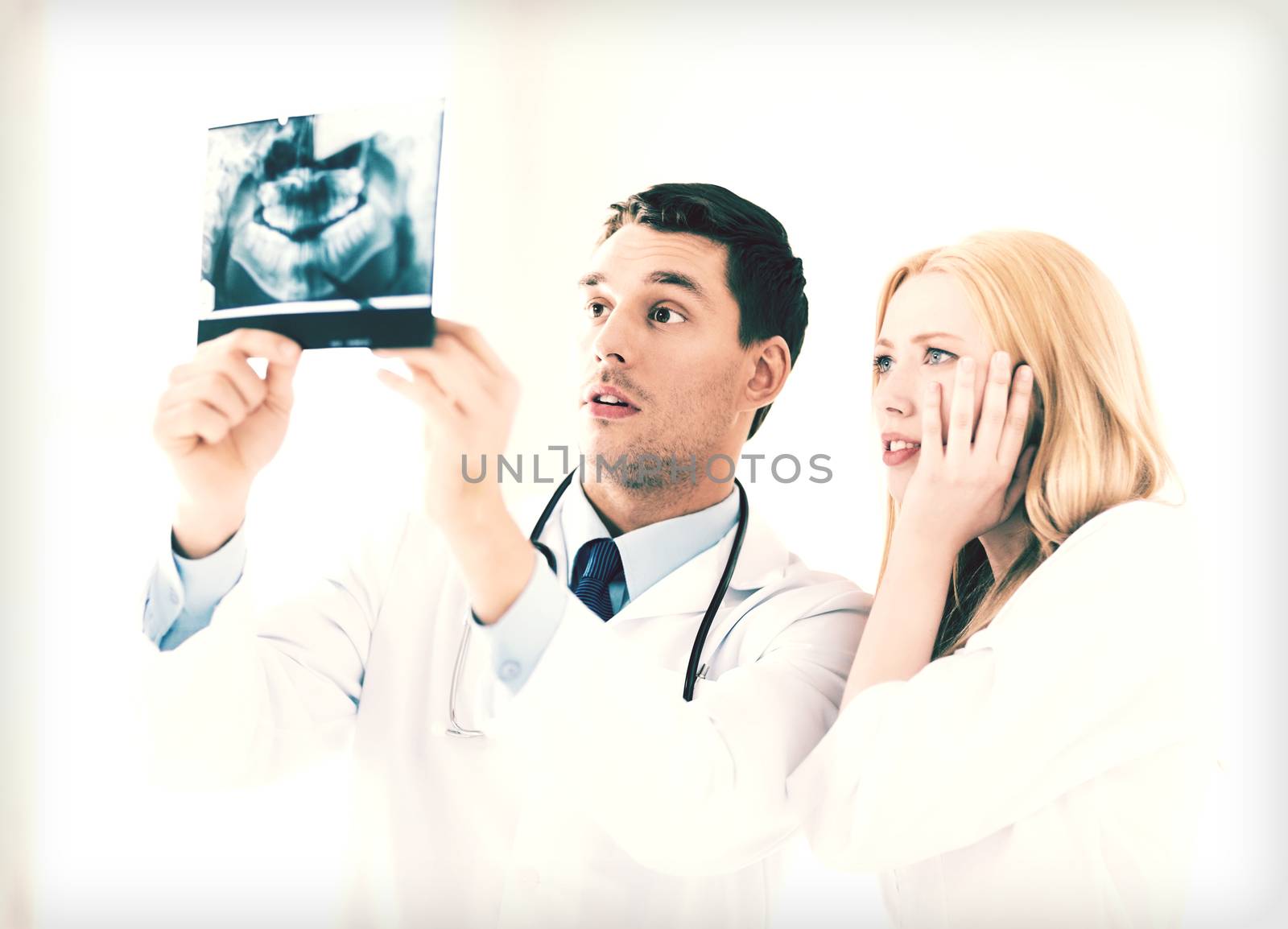 two doctors looking at x-ray by dolgachov