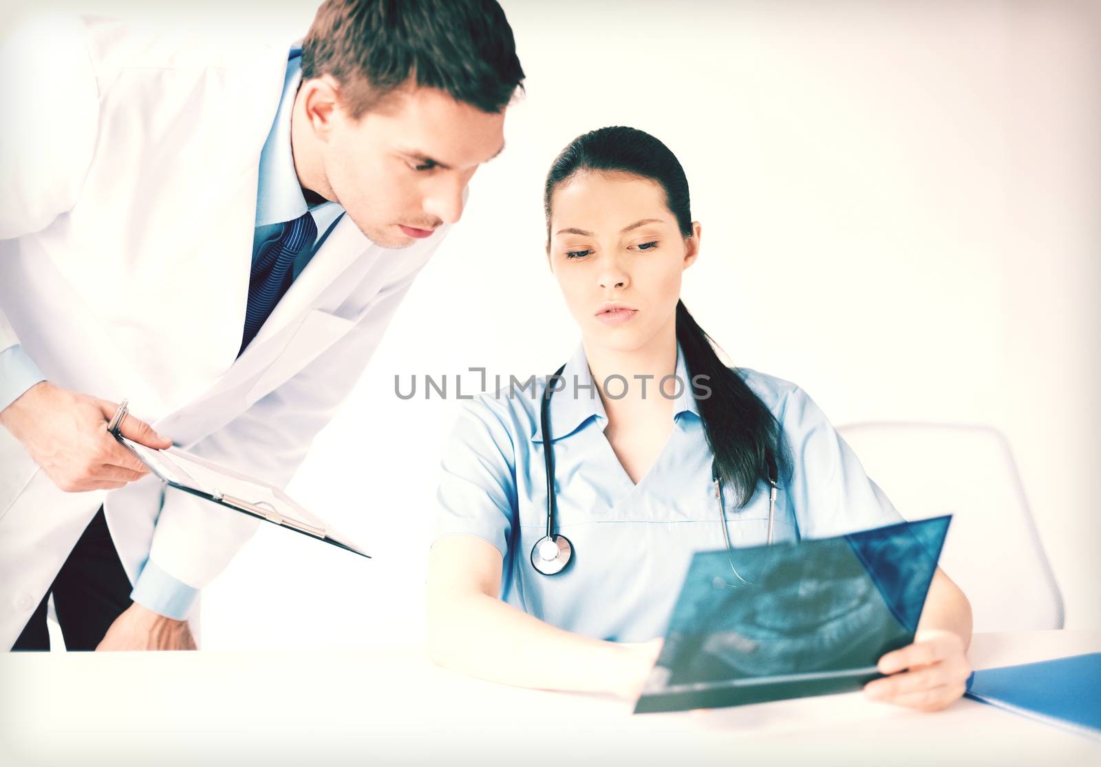 picture of two medical workers looking at x-ray