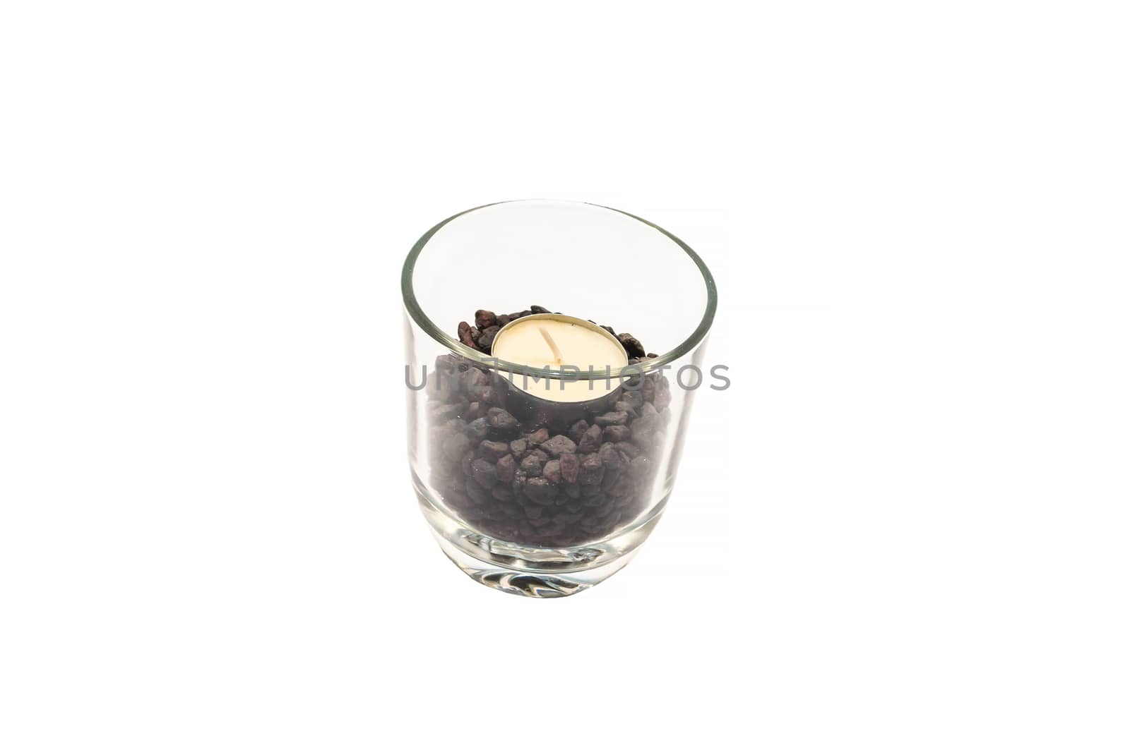 Candle in a transparent glass on a white background