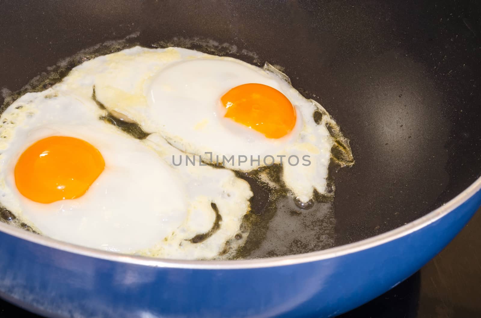 Farmers breakfast, two eggs in a pan.